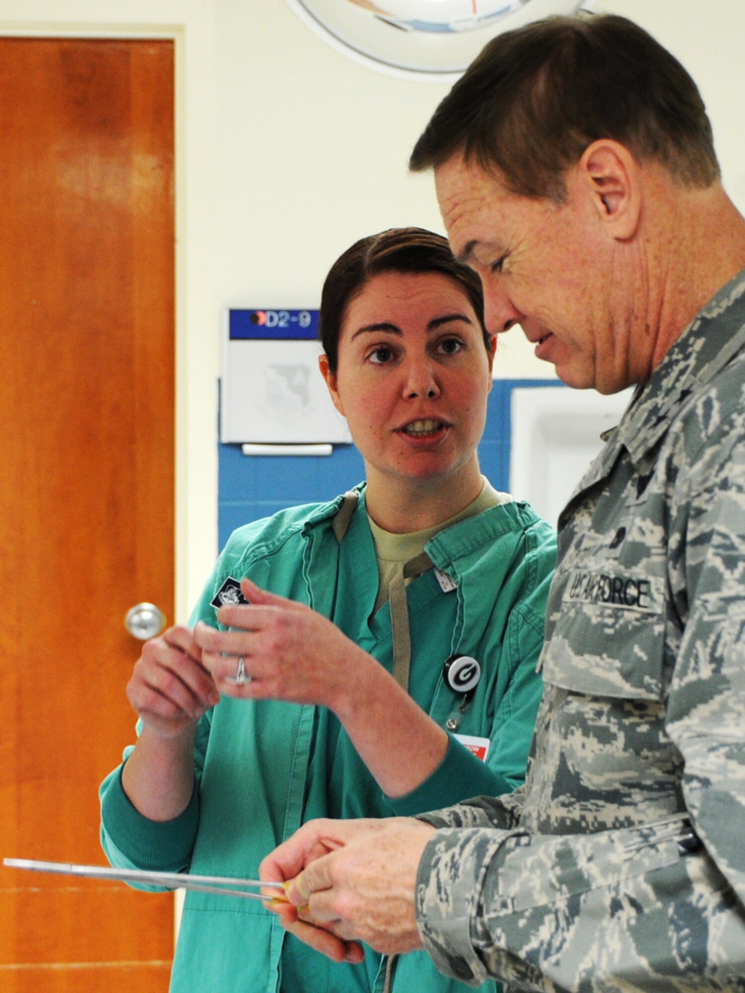Staff Sgt. Tamara Bruinink, 79th MDW surgical room technician, briefs Major Generals Darryl Burke, Air Force District of Washington commander, on operating room procedures at Joint Base Andrews, Md., Nov. 18, 2014. Burke visited medical facilities and met staff during his 779th Medical Group immersion tour.  (U.S. Air Force photo/Staff Sgt. Matt Davis)