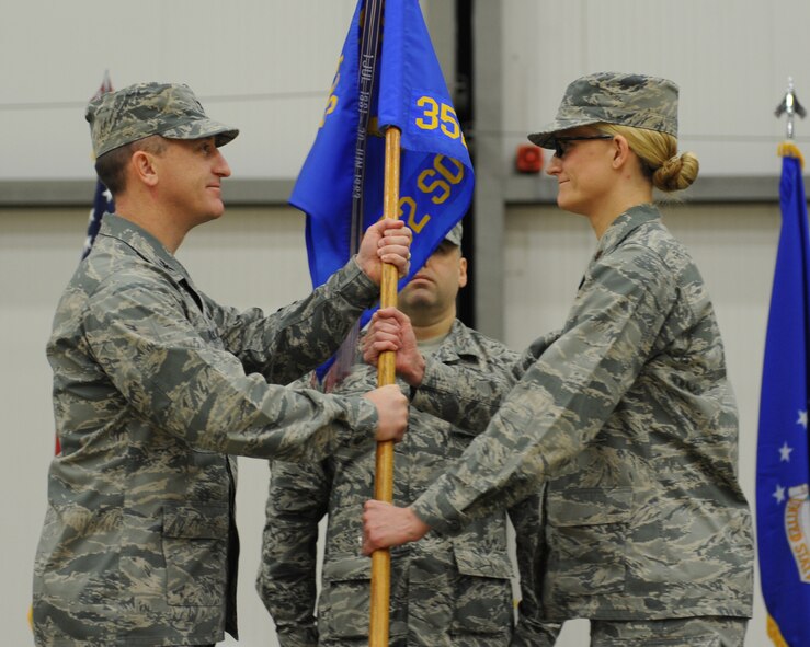 U.S. Air Force Col. Nathan Green, left, 352nd Special Operations Group commander, passes the 352nd SOMXS guidon to U.S. Air Force Maj. Seanna Less, 352nd Special Operations Maintenance Squadron commander, during the 352nd SOMXS change of command Nov. 19, 2014, in Hanger 803 at RAF Mildenhall, England. The 352nd SOMXS is the largest U.S. Air Force squadron in Europe. (U.S. Air Force photo by Airman 1st Class Preston Webb/Released)