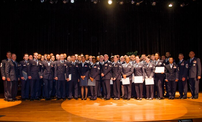 Col. Jeffrey DeVore, 628th Air Base Wing commander (front left), Col. Jimmy Canlas, 437th Airlift Wing vice commander (right), Chief Master Sgt. Mark Bronson, 628th Air Base Wing command chief (back left), Chief Master Sgt. Shawn Hughes, 437th Airlift Wing command chief (second from right) and Chief Master Sgt. Debra Mosley, 628th Force Support Squadron superintendent (third from right) pose for a group photo with Airmen who have reached a career milestone by earning their Community College of the Air Force degrees Nov. 18, 2014, at Joint Base Charleston, S.C. More than 50 Airmen were recognized during the ceremony. (U.S. Air Force photo / Senior Airman Tom Brading)