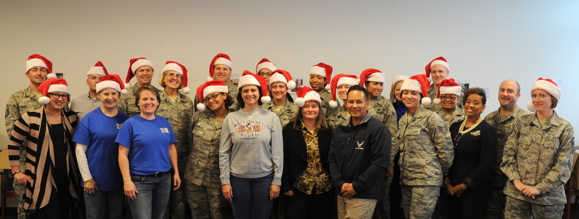 Members of the Air Force District of Washington pose for a photo during the unit’s holiday care package packing event at Joint Base Andrews, Md., Nov. 17, 2014. This year’s holiday packages were packed in the memory of Senior Airman Daniel James Johnson, an explosive ordnance disposal technician, who was killed in Afghanistan by an improvised explosive device in 2010. (U.S. Air Force photo/Chief Master Sgt. Henry Hayes, Jr.)