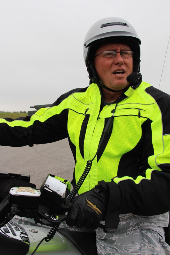 Senior Master Sgt. William Bassett, 932nd Airlift Wing, Superintendent of the Scott Command Post, looks over his shoulder for traffic and takes a minute to discuss the importance of motorcycle safety, while posing with his winterized, heated seast and heated grips, Honda Goldwing. "No matter how short the distance, always wear a helmet", said Bassett. He continued with his warning, "most accidents are going to happen in a parking lot, or within a few miles of your house.  (U.S. Air Force Photo/Maj. Stan Paregien) 