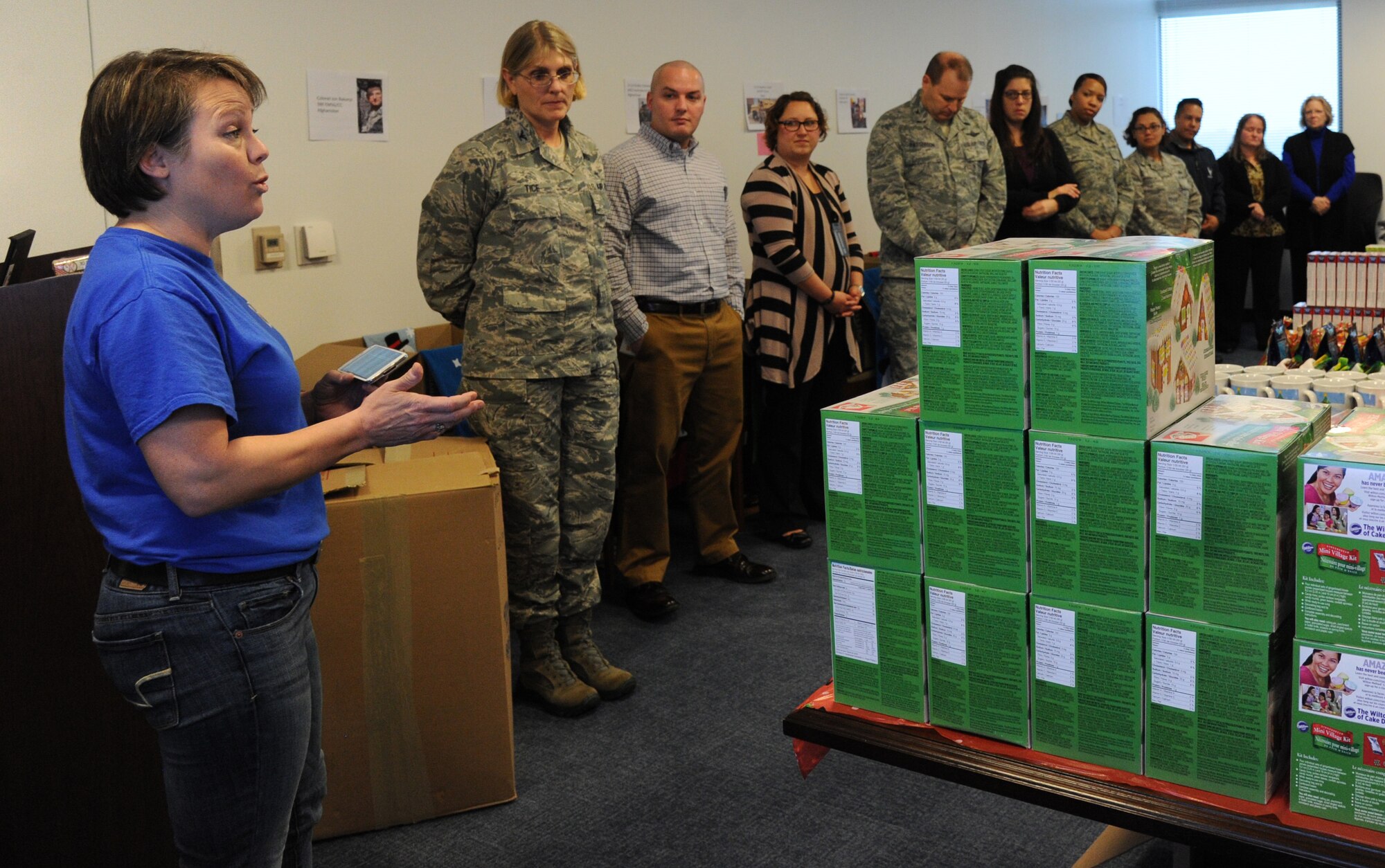 Annette Bonaro explains the meaning behind the assembly of care packages for Airmen deployed from the Air Force District of Washington at Joint Base Andrews, Md., Nov. 17, 2014. This year’s holiday packages were packed in the memory of Senior Airman Daniel James Johnson, an explosive ordnance disposal technician, who was killed in Afghanistan by an improvised explosive device in 2010. Bonaro is the AFDW unit deployment manager. (U.S. Air Force photo/Master Sgt. Tammie Moore)