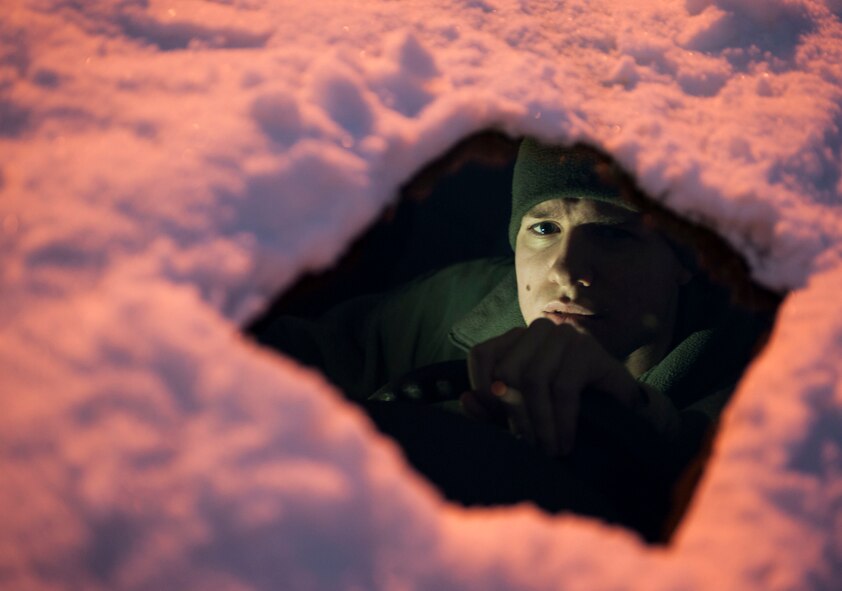 Senior Airman Thomas Stang, 5th Security Forces Squadron installation entry controller, demonstrates “peep-hole-driving” on Minot Air Force Base, N.D. Nov. 13, 2014. “Peep-hole-driving” is a driving practice in which only a small area of the front windshield is cleared leaving drivers vulnerable on all other sides. (U.S. Air Force photo/Senior Airman Stephanie Morris)