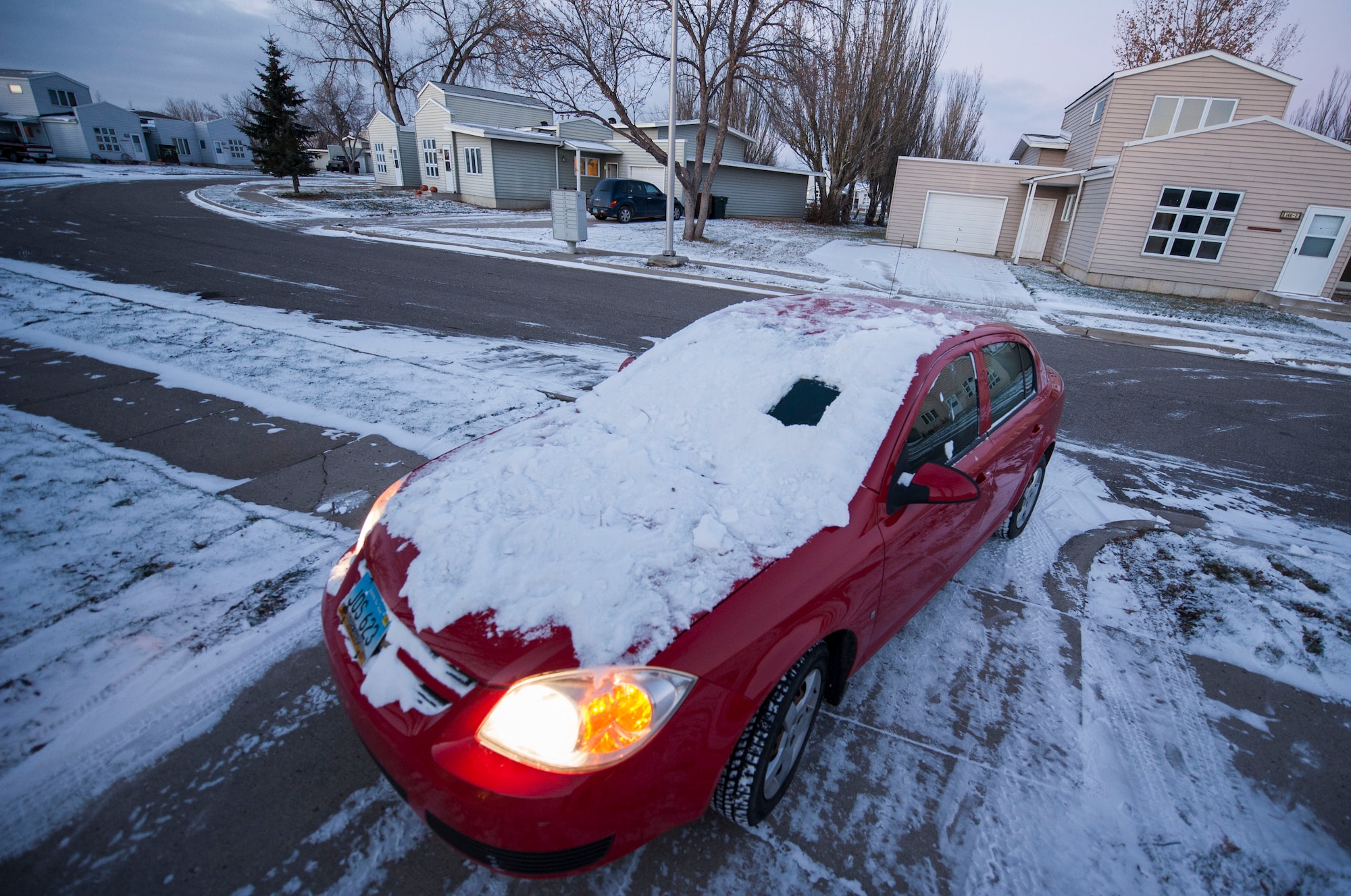 An example of “peep-hole-driving” is shown on Minot Air Force Base, N.D. Nov. 13, 2014. Nov. 11, marked the first snowfall of winter on base. With the snow comes a variety of driving challenges: needing to clear windshields, reduce speeds and leave earlier to reach destinations.  (U.S. Air Force photo/Senior Airman Stephanie Morris)