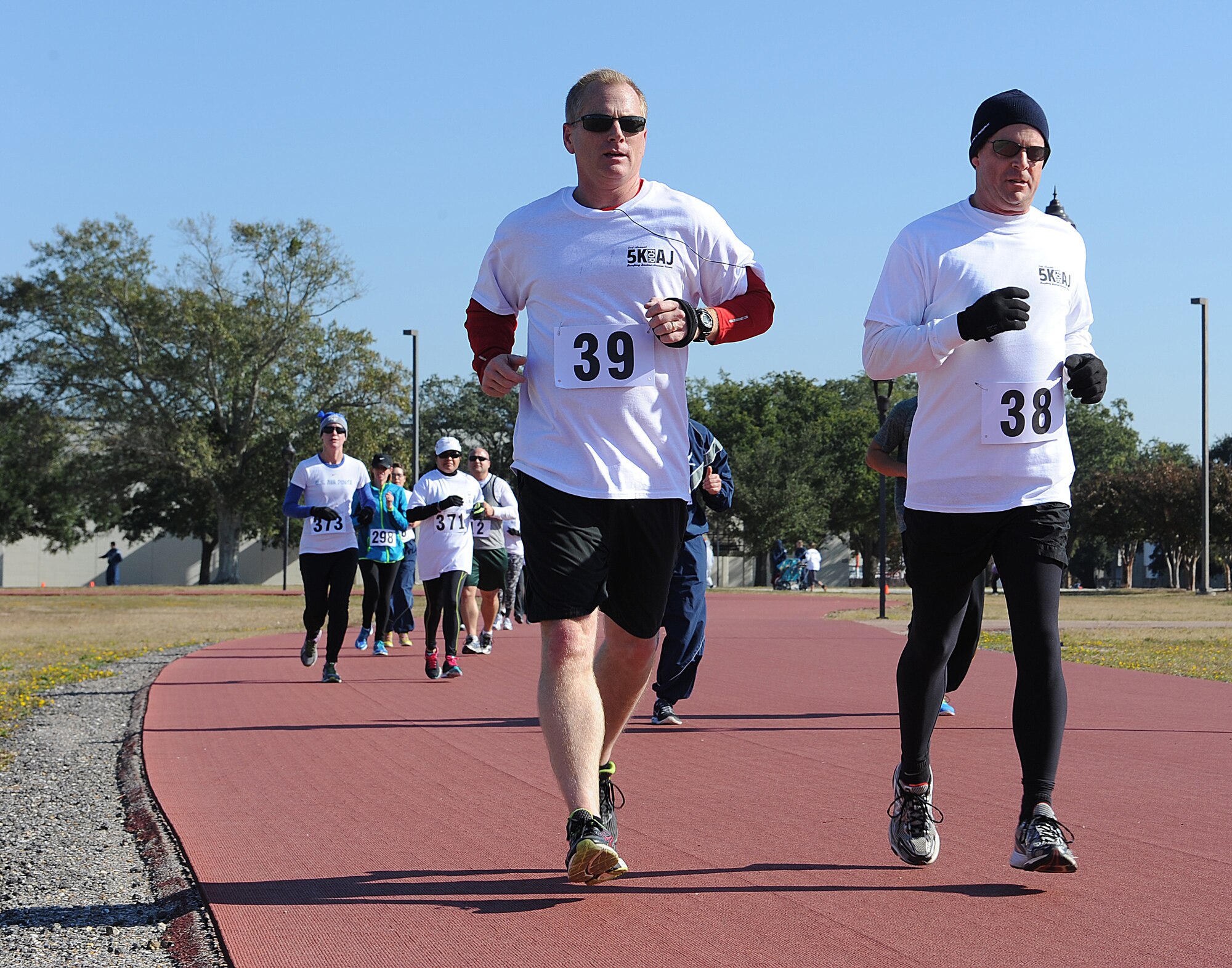 Col. Dennis Scarborough, 81st Training Wing vice commander, Col. Frank Amodeo, 403rd Wing commander, run during the second annual 5K for AJ Nov. 15, 2014, Keesler Air Force Base, Miss. The event raised more than $5,000 for the Disabled American Veterans Charity and drew approximately 300 participants. (U.S. Air Force photo by Senior Airman Holly Mansfield/Released) 