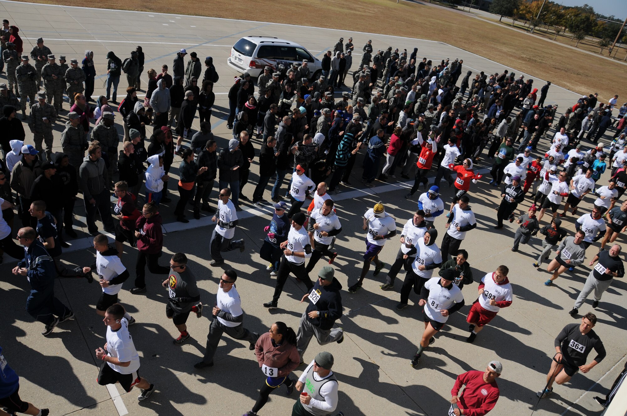 Participants in the second annual 5K for AJ start the race at the Triangle Drill Pad Nov. 15, 2014, Keesler Air Force Base, Miss. The event raised more than $5,000 for the Disabled American Veterans charity and drew approximately 300 participants. Last year’s 5K for AJ raised money for retired Master Sgt. Albert “AJ” Jackson, who was diagnosed with Marfan Syndrome. (U.S Air Force photo by Airman 1st Class Duncan McElroy/Released)