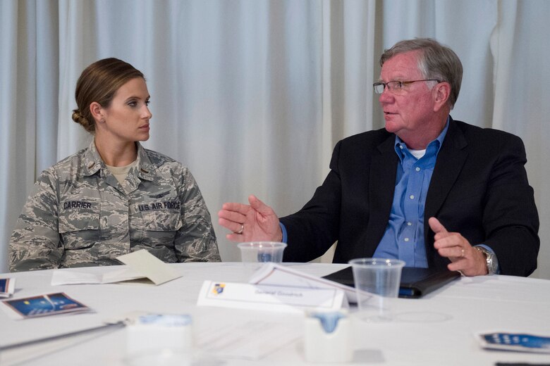 First Lt. Leah Carrier, 1st Range Operations Squadron, engages in conversation with retired Brig. Gen. Dan Goodrich, during the Bars to Stars Symposium at Patrick Air Force Base, Fla., Nov. 14, 2014. General officers met with company grade officers to foster communication and provide mentorship. (U.S. Air Force photo/Matthew Jurgens) (Released)