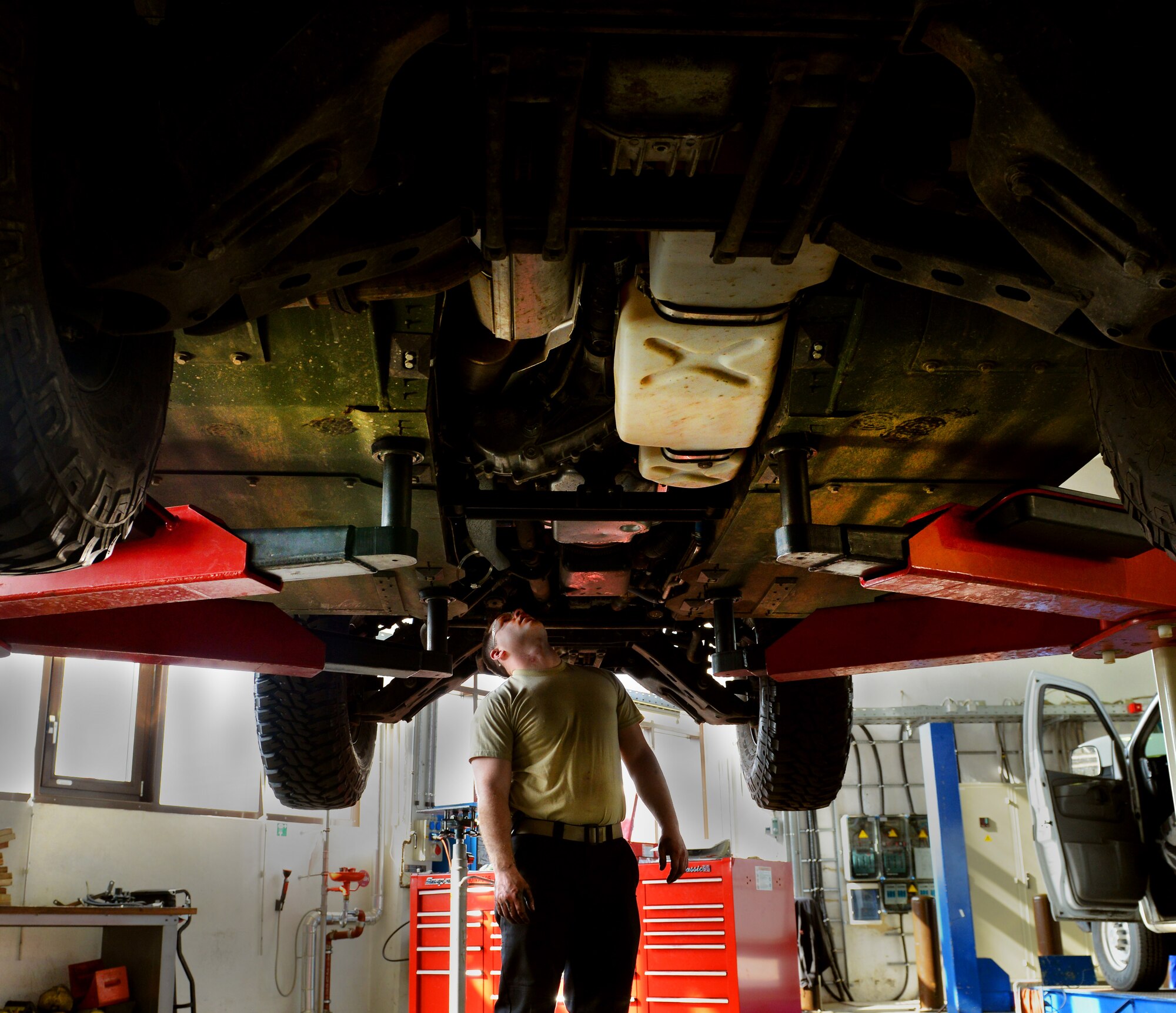 Senior Airman Brian Klockow, 86th Vehical Readiness Squadron light vehical mechanic, inspects radiator hoses under a Humvee, April 1, 2014 at Ramstein Air Base, Germany. (U.S. Air Force photo/ Airman Dymekre Allen)