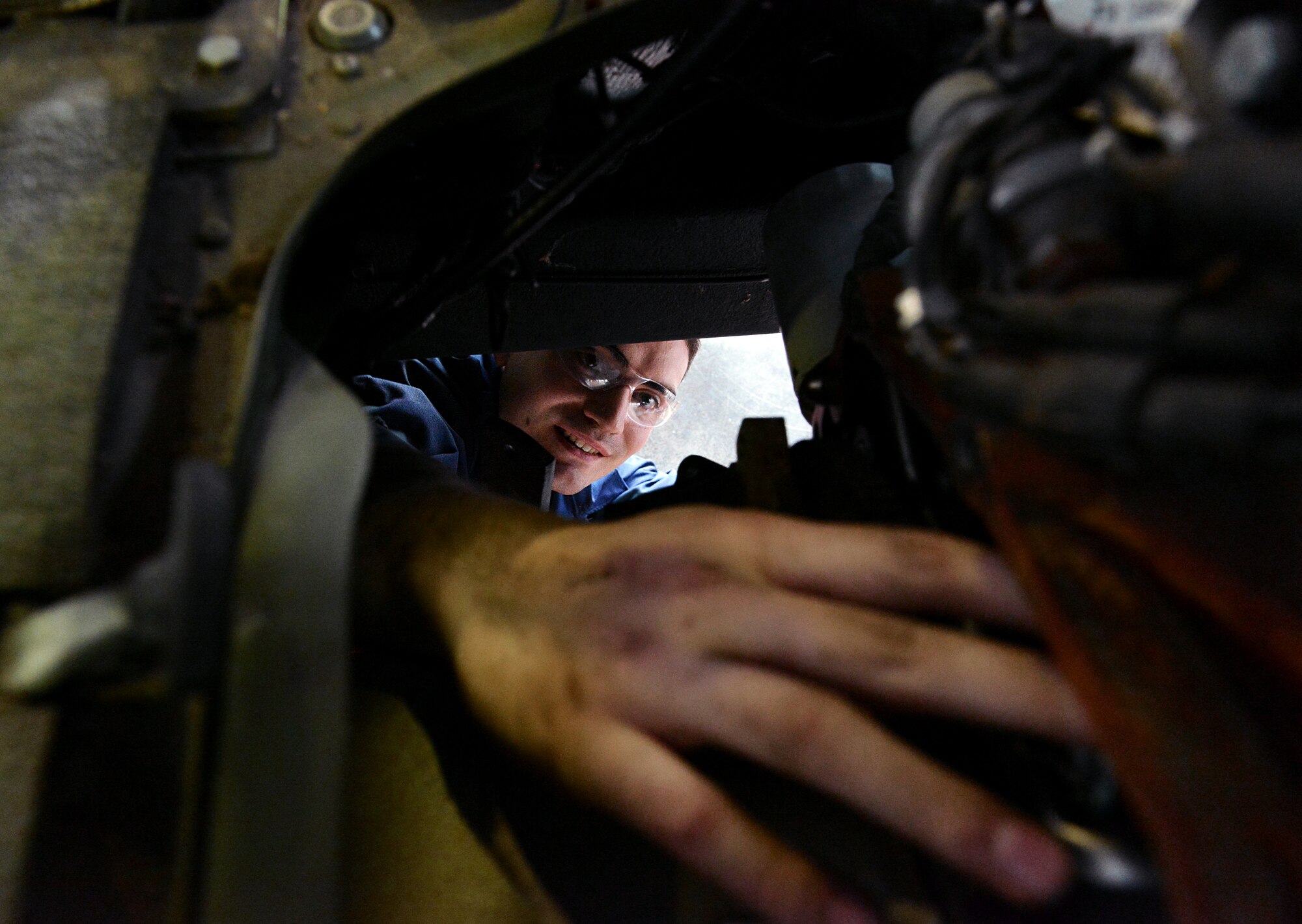 Airman 1st Class Lorne Abshire, 86th Vehicle Readiness Squadron light vehicle mechanic, checks the transmission  of a Humvee, April 1, 2014 at Ramstein Air Base, Germany. (U.S. Air Force photo/ Airman Dymekre Allen)