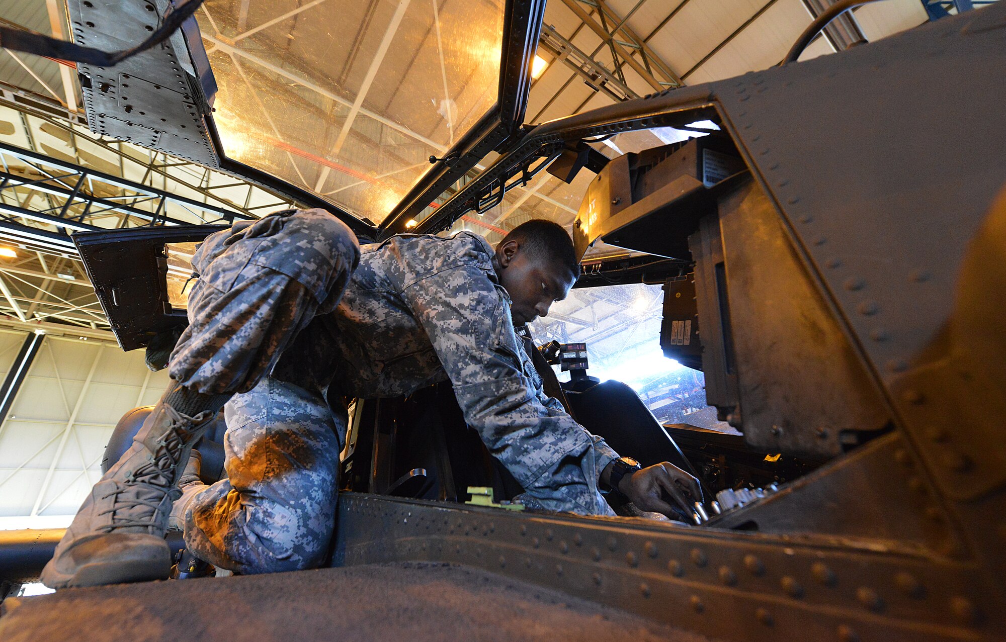 Army Pfc. Anfernee Shepard, 412th Aviation Support Battalion Bravo company AH-64D Apache Helicopter armament electrical repair mechanic, checks for loose bolts during a blade folding mission March 26, 2014, at Ramstein Air Base, Germany. An eight-man team of soldiers visited Ramstein to repair and mobilize eight Apache attack helicopters from illeshei, Germany. The ten-day assignment began on March 18 and was completed March 28. The mission consisted of inspections and equipment checks before being loaded up and shipped back to a deployed location in a C-17 Globe Master III. The mission allowed them to work alongside Air Force members in a joint effort to prepare the Apaches for operations down-range. (U.S. Air Force photo/Airman Dymekre Allen)  