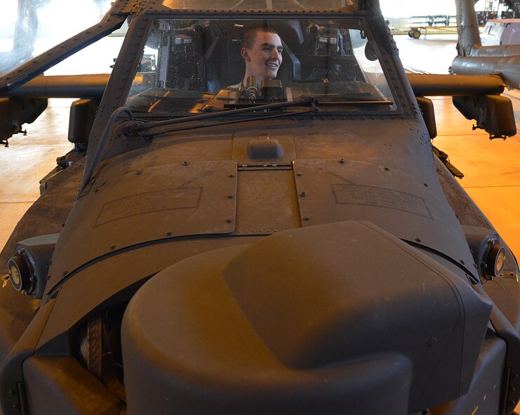 Army Pfc. Dillon Burnhauser, 412th Aviation Support Battalion Bravo company AH-64D Apache Helicopter armament electrical repair mechanic, inspects the an Apache for electrical malfunctions during a blade folding mission March 26, 2014, at Ramstein Air Base, Germany. An eight-man team of soldiers visited Ramstein to repair and mobilize eight Apache attack helicopters from illeshei, Germany. The ten-day assignment began on March 18 and was completed March 28. The mission consisted of inspections and equipment checks before being loaded up and shipped back to a deployed location in a C-17 Globe Master III. The mission allowed them to work alongside Air Force members in a joint effort to prepare the Apaches for operations down-range. (U.S. Air Force photo/Airman Dymekre Allen)  