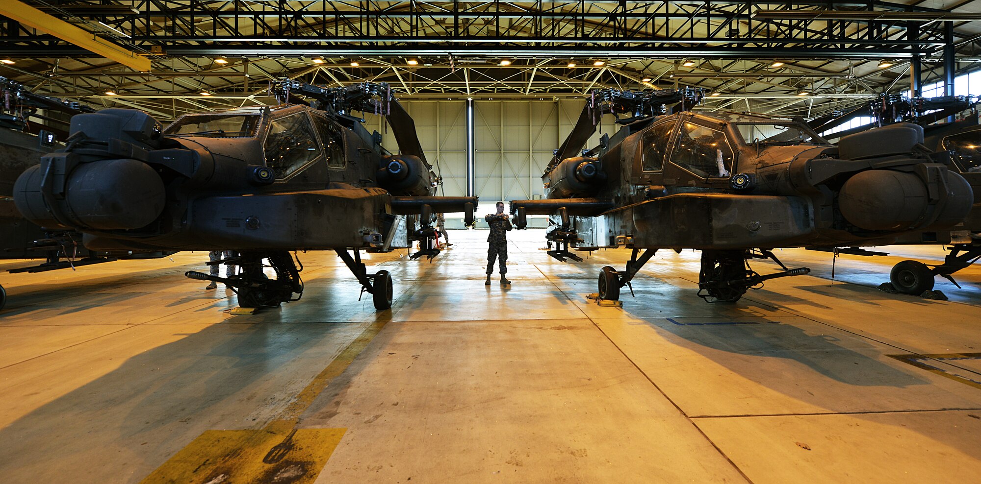 Army Pfc. Dillon Burnhauser, 412th Aviation Support Battalion Bravo company AH-64D Apache attack Helicopter armament electrical repair mechanic, runs through inspection checks during a blade folding mission March 26, 2014, at Ramstein Air Base, Germany. An eight-man team of soldiers visited Ramstein to repair and mobilize eight Apache attack helicopters from illeshei, Germany. The ten-day assignment began on March 18 and was completed March 28. The mission consisted of inspections and equipment checks before being loaded up and shipped back to a deployed location in a C-17 Globe Master III. The mission allowed them to work alongside Air Force members in a joint effort to prepare the Apaches for operations down-range. (U.S. Air Force photo/Airman Dymekre Allen)  