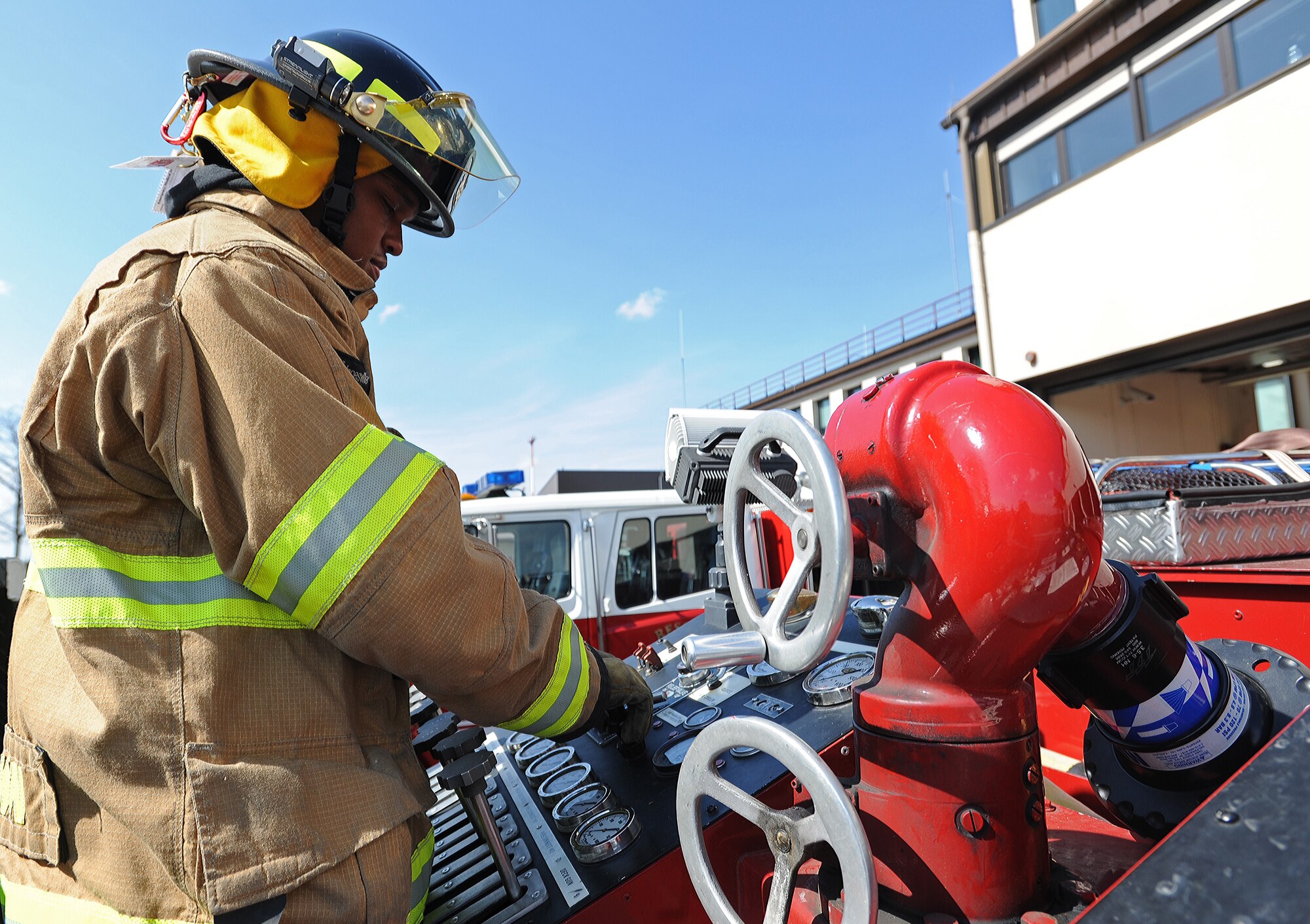 Airman 1st Class Tevin Brown, 86th Civil Engineer Squadron fire fighter, inspects different parts of a fire truck April 2, 2014, at Ramstein Air Base, Germany. The Ramstein Fire Department recently received the Air force Fire Department of the Year Award for its members’ excellence in fire safety. (U.S. Air Force photo/Airman 1st Class Holly Mansfield)