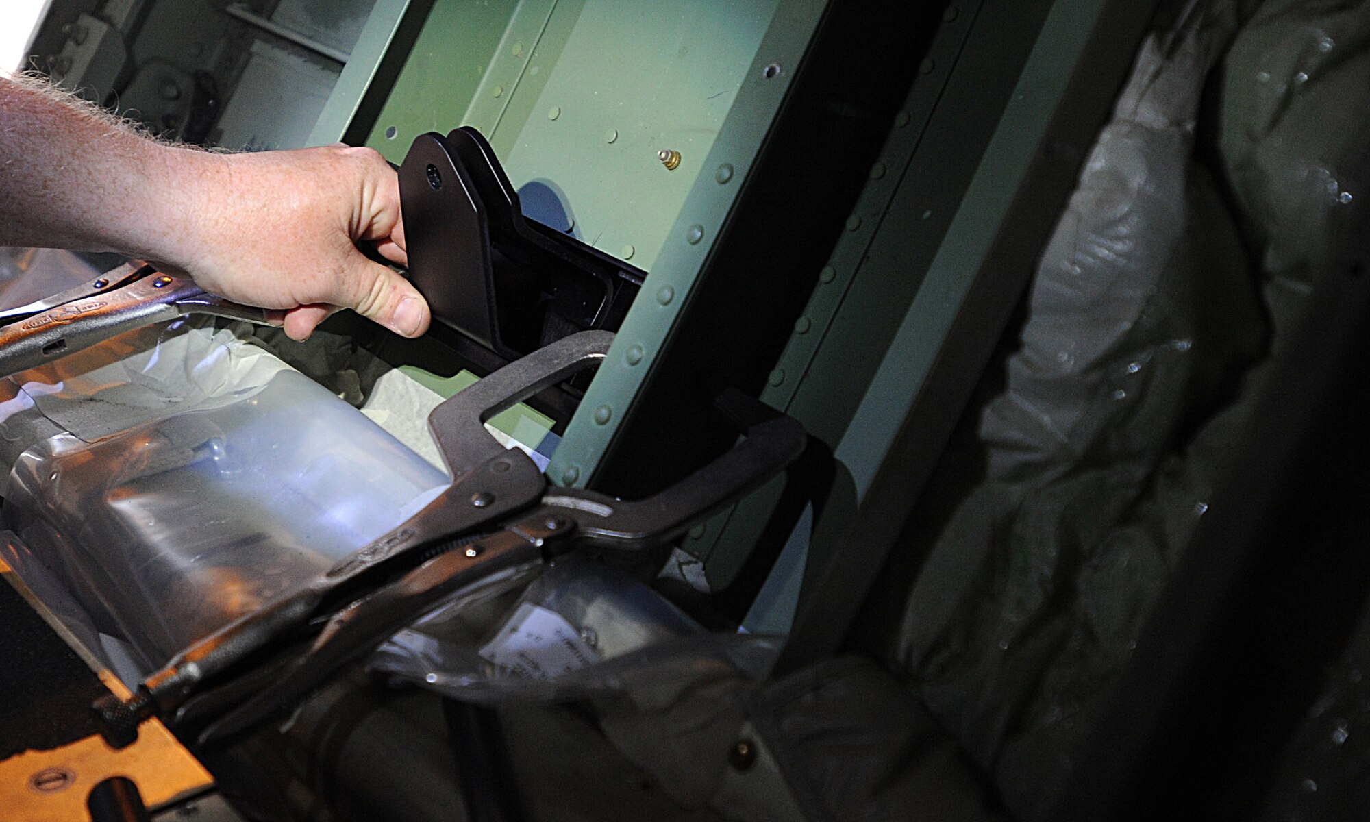 Joel Rykard, 560th Aircraft Maintenance Squadron mechanic from Robbins Air Force Base, Georgia, prepares a C-130J Super Hercules to be compatible for a new seat as part of the Time Compliance Technical Order configuration April 4, 2014, at Ramstein Air Base, Germany. The new seat will enable loadmasters to have an approved seat for take-offs and landings and will increase their survivability in the event of a hard landing or crash. It will also allow the loadmaster to safely scan for surface-to-air weapons while in flight.(U.S. Air Force photo/Airman 1st Class Holly Mansfield)