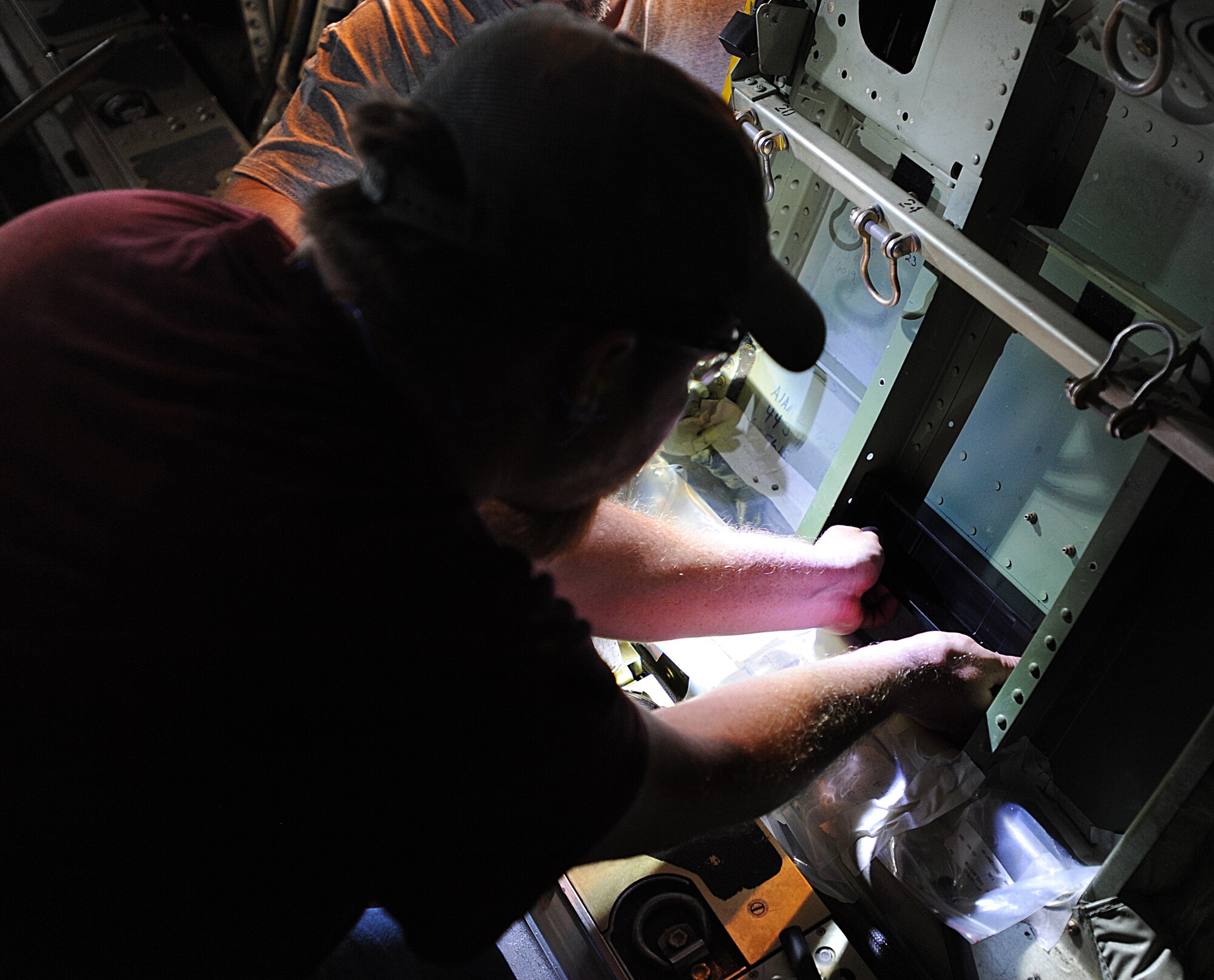 Joel Rykard, 560th Aircraft Maintenance Squadron mechanic from Robbins Air Force Base, Georgia, prepares a C-130J Super Hercules to be compatible for a new seat as part of the Time Compliance Technical Order configuration April 4, 2014, at Ramstein Air Base, Germany. The new seat will enable loadmasters to have an approved seat for take-offs and landings and will increase their survivability in the event of a hard landing or crash. It will also allow the loadmaster to safely scan for surface-to-air weapons while in flight.(U.S. Air Force photo/Airman 1st Class Holly Mansfield)