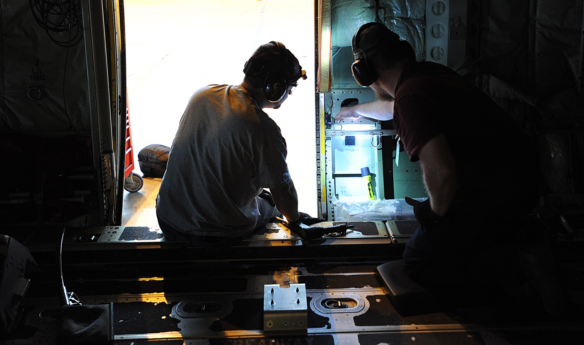 Zach Edens (left) and Joel Rykard, 560th Aircraft Maintenance Squadron mechanics from Robbins Air Force Base, Georgia, prepare a C-130J Super Hercules to be compatible for a new seat as part of the Time Compliance Technical Order configuration April 4, 2014, at Ramstein Air Base, Germany. The new seat will enable loadmasters to have an approved seat for takeoffs and landings and will increase their survivability in the event of a hard landing or crash. It will also allow the loadmaster to safely scan for surface-to-air weapons while in flight.(U.S. Air Force photo/Airman 1st Class Holly Mansfield)photo/Airman 1st Class Holly Mansfield)