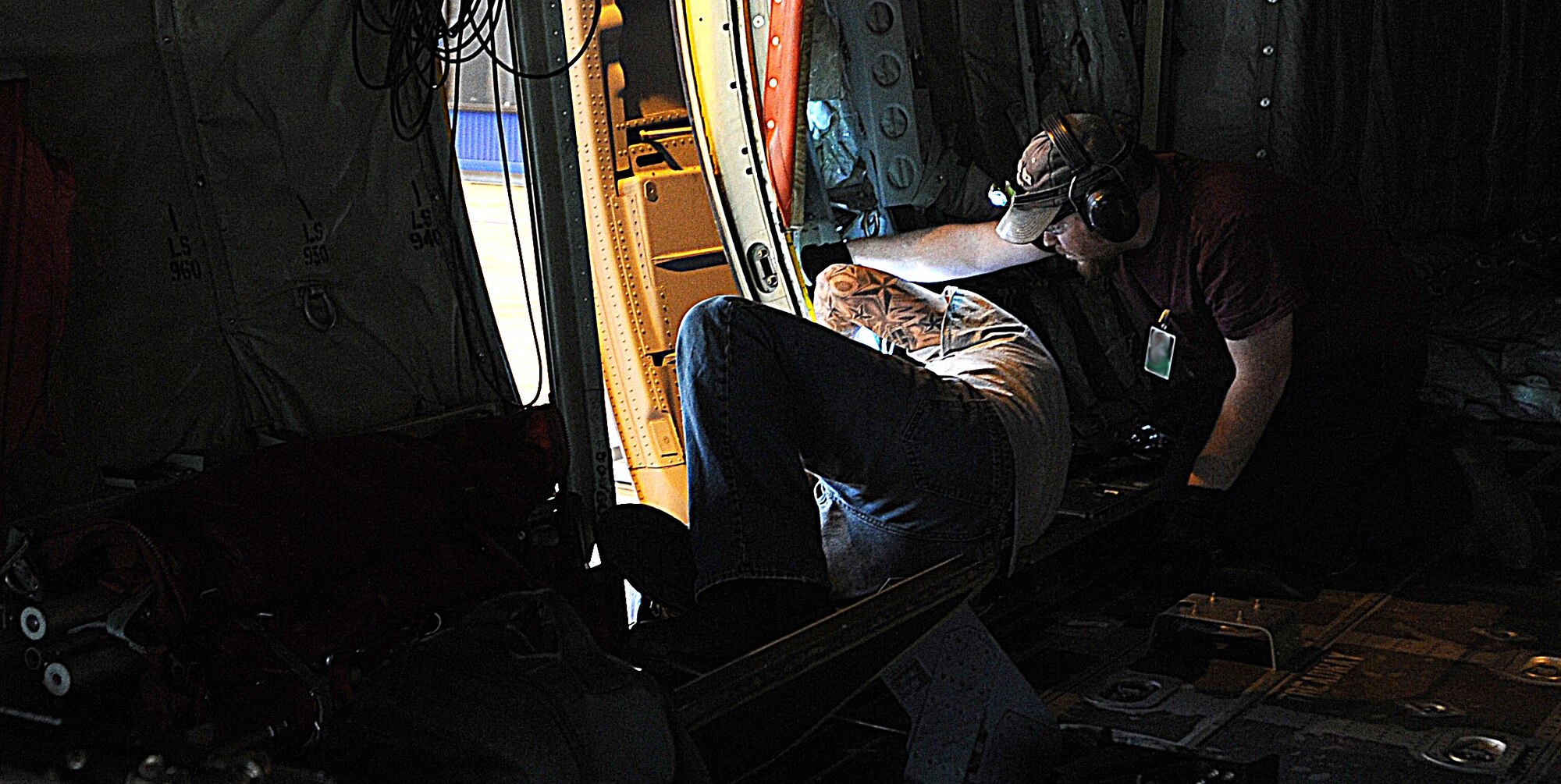 Zach Edens (left) and Joel Rykard, 560th Aircraft Maintenance Squadron mechanics from Robbins Air Force Base, Georgia, prepare a C-130J Super Hercules to be compatible for a new seat as part of the Time Compliance Technical Order configuration April 4, 2014, at Ramstein Air Base, Germany. The new seat will enable loadmasters to have an approved seat for takeoffs and landings and will increase their survivability in the event of a hard landing or crash. It will also allow the loadmaster to safely scan for surface-to-air weapons while in flight.(U.S. Air Force photo/Airman 1st Class Holly Mansfield)photo/Airman 1st Class Holly Mansfield)