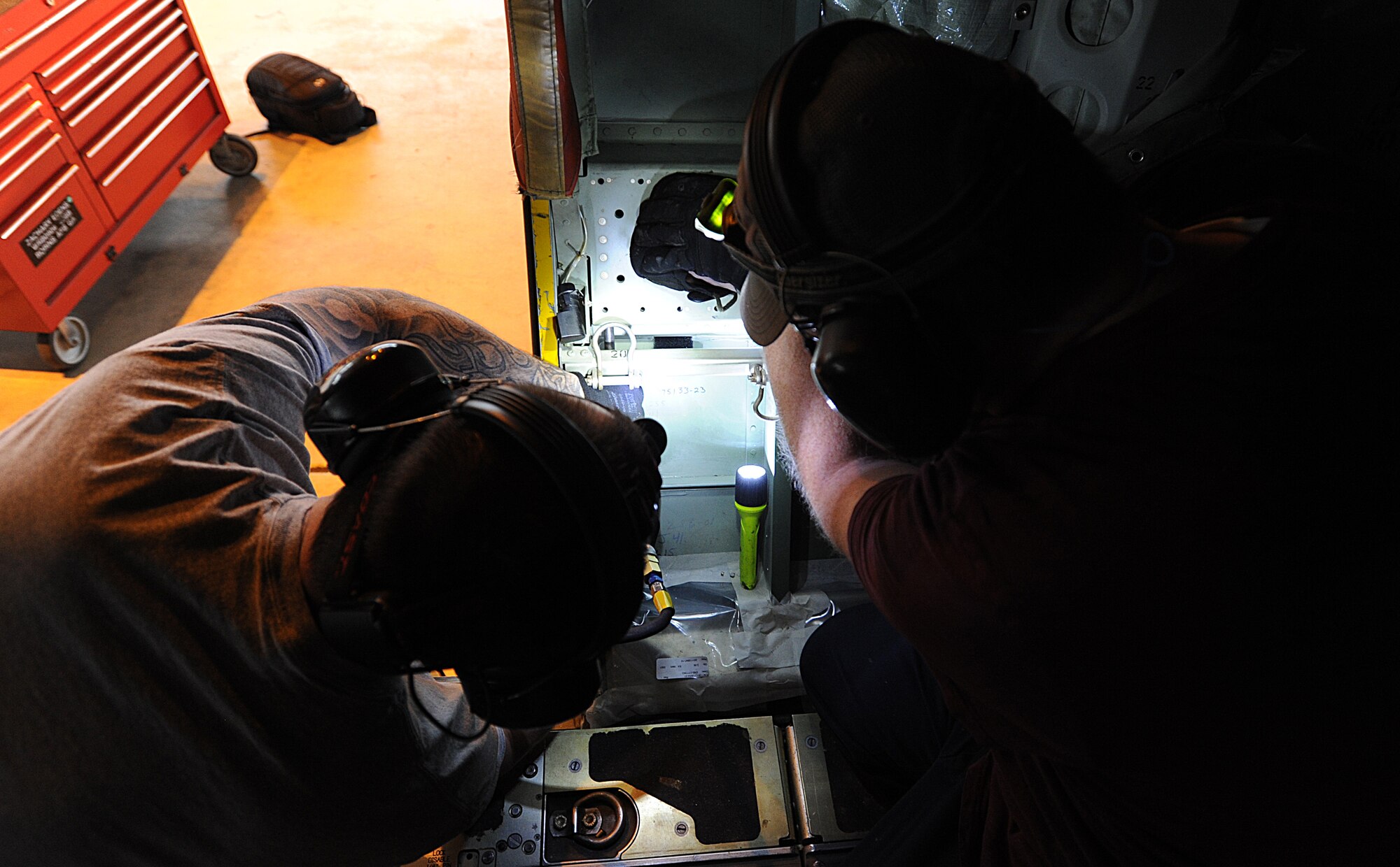 Zach Edens (left) and Joel Rykard, 560th Aircraft Maintenance Squadron mechanics from Robbins Air Force Base, Georgia, prepare a C-130J Super Hercules to be compatible for a new seat as part of the Time Compliance Technical Order configuration April 4, 2014, at Ramstein Air Base, Germany. The new seat will enable loadmasters to have an approved seat for takeoffs and landings and will increase their survivability in the event of a hard landing or crash. It will also allow the loadmaster to safely scan for surface-to-air weapons while in flight.(U.S. Air Force photo/Airman 1st Class Holly Mansfield)photo/Airman 1st Class Holly Mansfield)