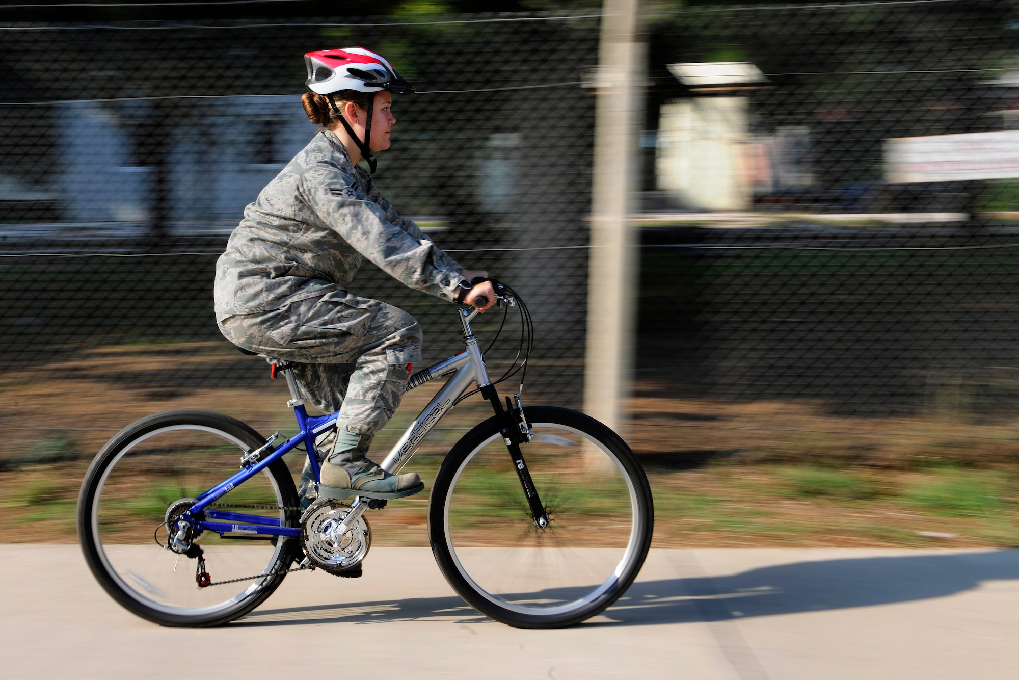 A bicyclist rides a bike wearing proper protective equipment Nov. 18, 2014, at Incirlik Air Base, Turkey. Bicyclists are required to follow the same rules and regulations of the road as  motor vehicle operators. (U.S. Air Force photo by Airman 1st Class Krystal Ardrey/Released)