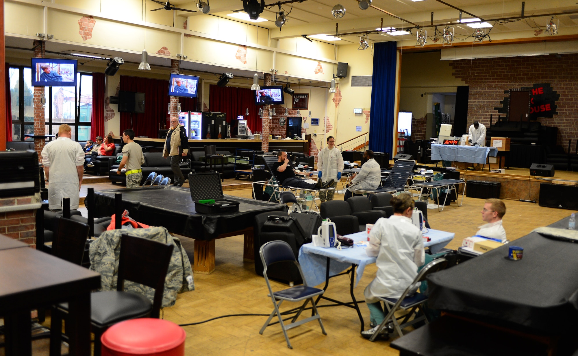 Blood donors and Landstuhl Regional Medical Ceneter laboratory technicians gather during an Armed Services Blood Program blood drive at the Brick House Community Center on Spangdahlem Air Base, Germany, Nov. 18, 2014. The ASBP travels to Spangdahlem approximately once every two months and facilitates more than 50 donors each visit. (U.S. Air Force photo by Airman 1st Class Luke Kitterman/Released)