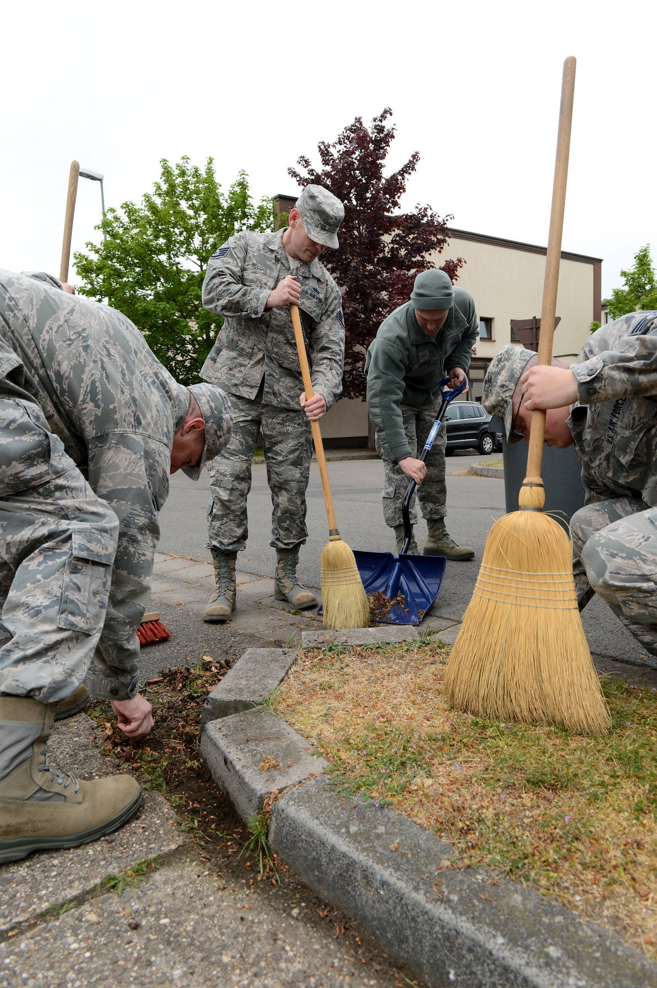 Airmen from the 86th Communications squadron ensure the streets surrounding their squadron are spotless during Base Pride Day on Ramstein Air Base, Germany, April 28th, 2014. Base Pride Day is a semi-annual two-day spring clean-up when Airmen clean where they live and work. (U.S. Air Force Photo/Airman 1st Class Michael Stuart)