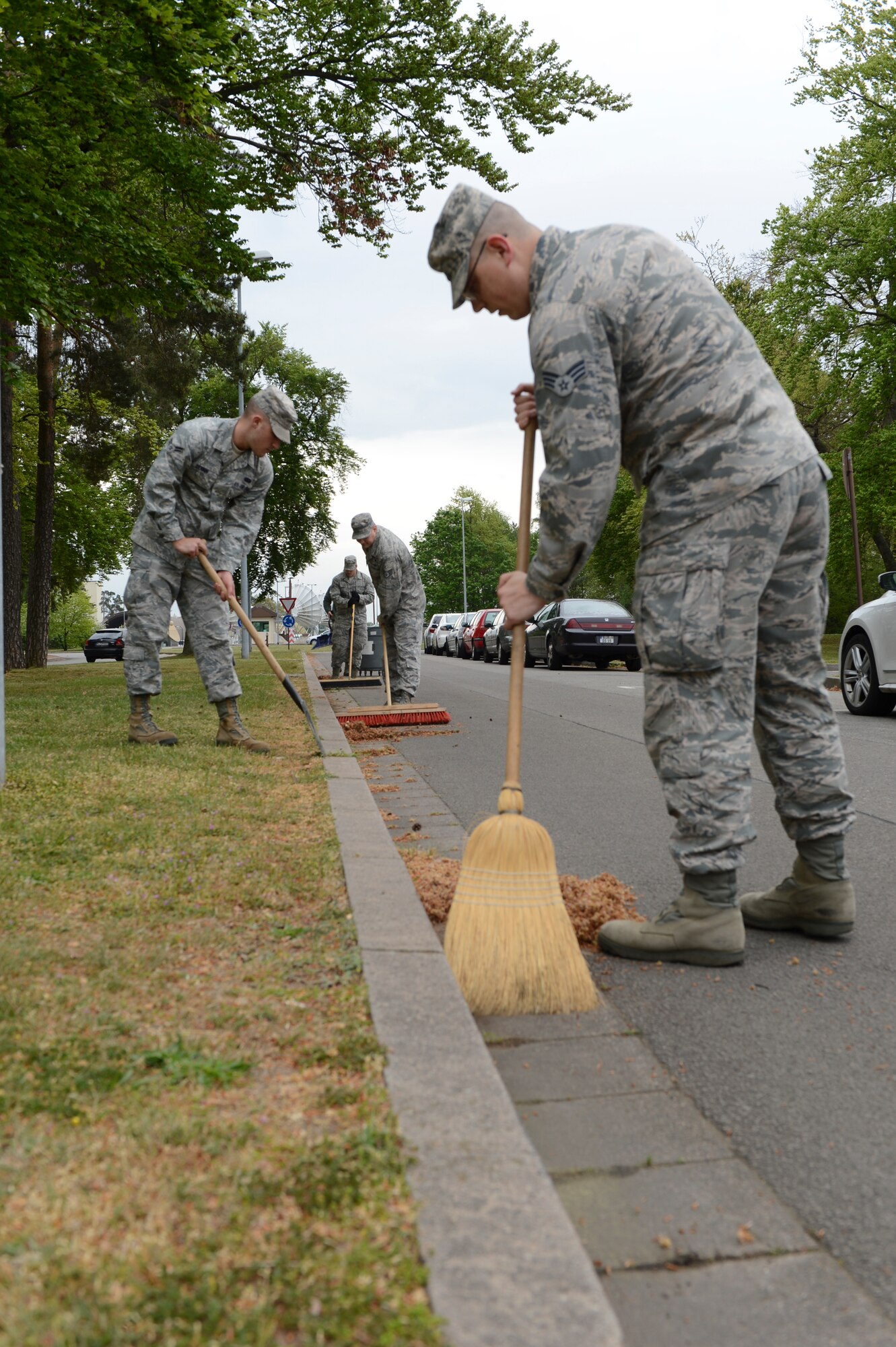 Airmen from the 86th Communications squadron ensure the streets surrounding their squadron are spotless during Base Pride Day on Ramstein Air Base, Germany, April 28th, 2014. Base Pride Day is a semi-annual two-day spring clean-up when Airmen clean where they live and work. (U.S. Air Force Photo/Airman 1st Class Michael Stuart)