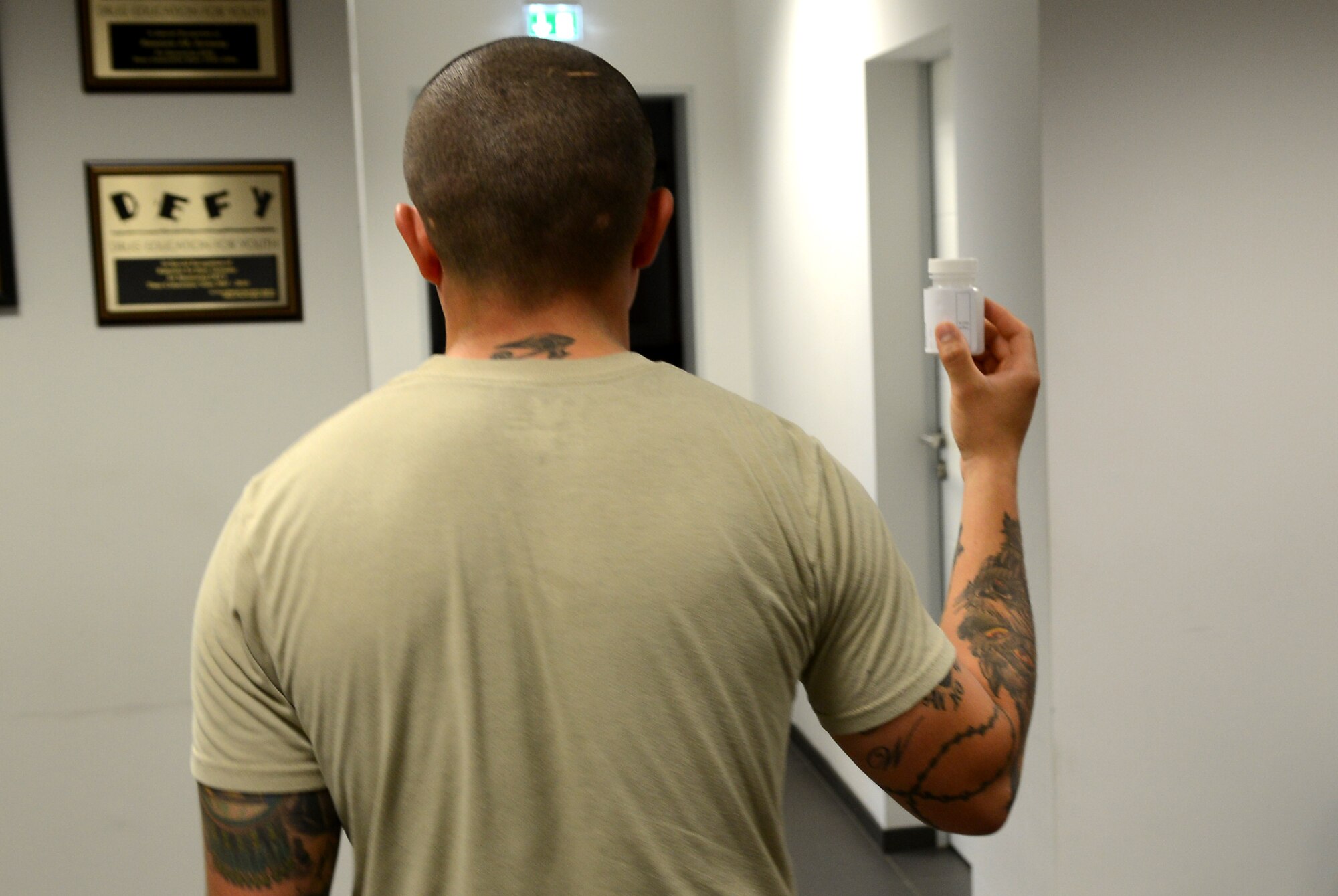 A Ramstein Air Base Airman takes a container to the restroom to provide a urine sample, June 9, 2014, Ramstein Air Base, Germany. Airmen from around Ramstein are selected at random to provide a urine sample as part of the Drug Demand Reduction Program. (U.S. Air Force photo/Senior Airman Jose L. Leon)