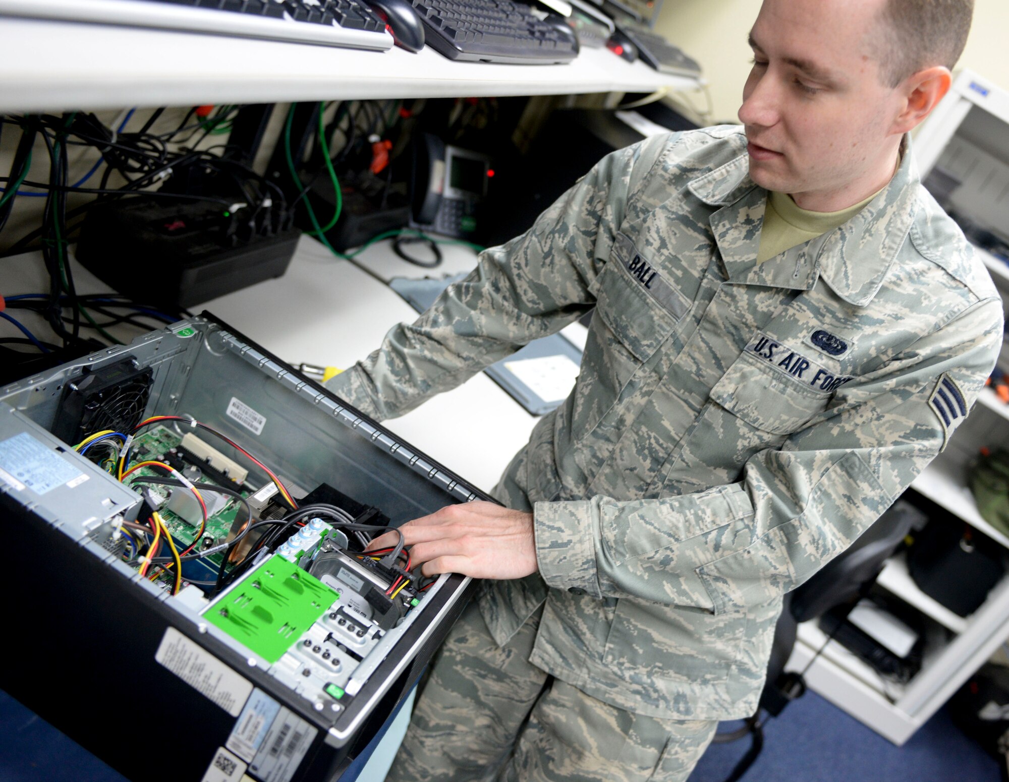 Senior Airman Chris Ball, 36th Communications Squadron client system technician, fixes an incorrectly installed heat sync, Nov. 19, 2014 on Andersen Air Force Base, Guam.  The 36th CS won the Air Force Information Dominance Small Unit Award for best communication squadron at the major command level for 2014. (U.S. Air Force photo by Staff Sgt. Robert Hicks/Released)  