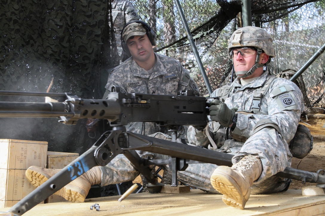 Army Sgt. Robert A. Ruiz demonstrates how to use an M2 machine gun ...