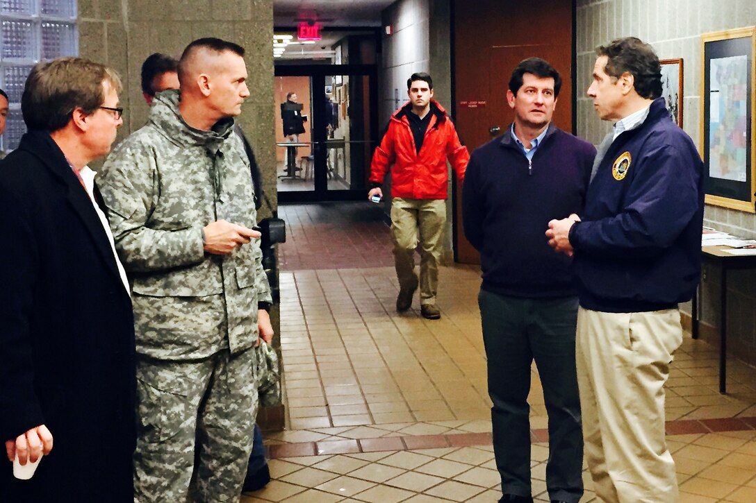 Army Maj. Gen. Patrick Murphy, second from left, adjutant general for the New York National Guard, speaks with New York Gov. Andrew M. Cuomo, right, and Erie County Executive Mark Poloncarz at an operations center in Cheektowaga, N.Y., Nov. 19, 2014. Cuomo toured the areas of western New York struck by historic snowfall levels and mobilized more than 240 Guardsmen to help remove the snow and control traffic. About 100 more Guardsmen were expected to arrive in the region to help.