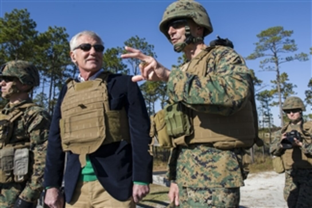 Defense Secretary Chuck Hagel observes female Marines fire shoulder-launched assault weapons on Camp Lejeune, N.C., Nov. 18. 2014. The Marines are assigned to Ground Combat Element Integrated Task Force. 