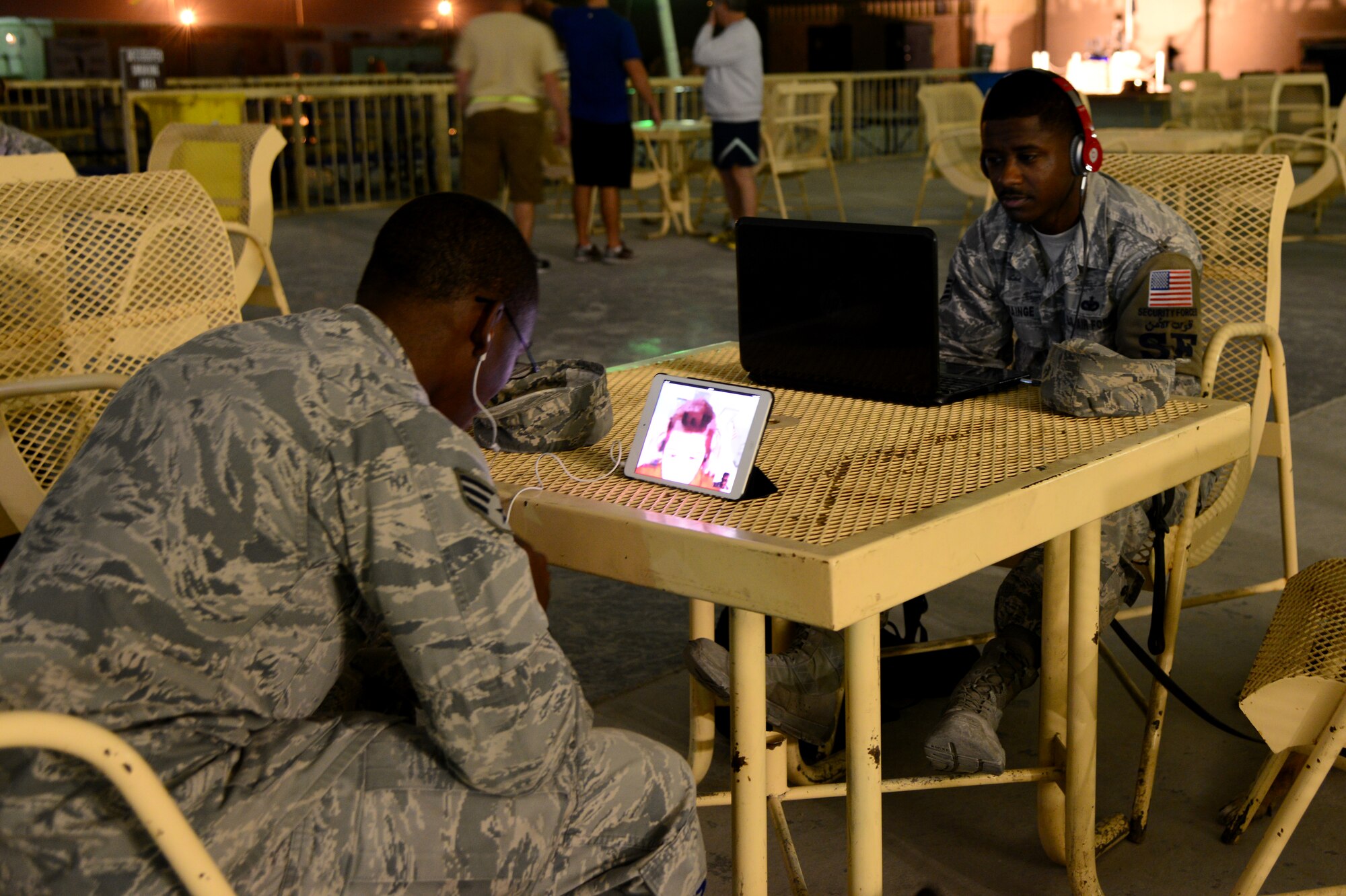 U.S. Air Force Senior Airman Elbert Foreman, left, and Staff Sgt. Corey Rainge, both 379th Expeditionary Security Forces Squadron military working dog handlers, video-chats with fifth-graders during the “Holler at a Hero” project Nov. 13, 2014, at Al Udeid Air Base, Qatar. The “Holler at a Hero” project was held in recognition of Veteran’s Day by a Security Forces veteran named James Wilson, who is now a teacher in New Jersey. The project allowed Wilson’s fifth grade class to have face-to-face interaction, via online video-messaging, with deployed service members to discuss their job duties, day-to-day activities and any personal challenges military members face while deployed. (U.S. Air Force photo by Senior Airman Kia Atkins)