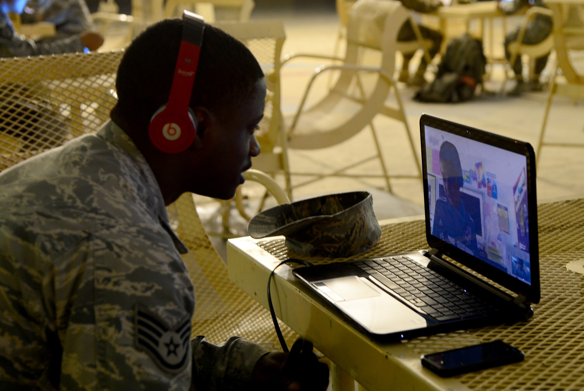 U.S. Air Force Staff Sgt. Corey Rainge, 379th Expeditionary Security Forces Squadron military working dog handler, video-chats with a fifth grade student during the “Holler at a Hero” project Nov. 13, 2014, at Al Udeid Air Base, Qatar. The “Holler at a Hero” project was held in recognition of Veteran’s Day by a Security Forces veteran named James Wilson, who is now a teacher in New Jersey. The project allowed Wilson’s fifth grade class to have face-to-face interaction, via online video-messaging, with deployed armed forces members to discuss their job duties, day-to-day activities and any personal challenges military members face while deployed. (U.S. Air Force photo by Senior Airman Kia Atkins)