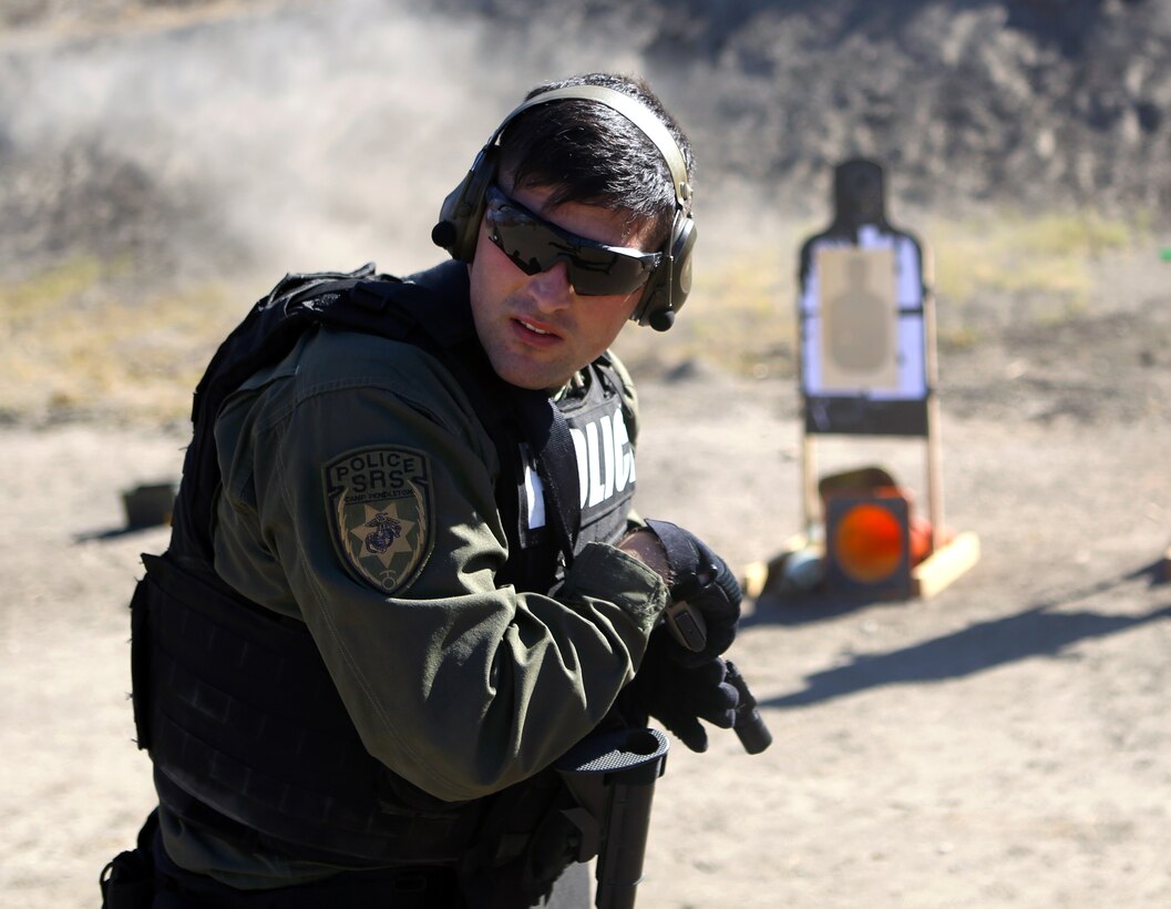 Cpl. Tyler Raffaele, an entry team breecher with the Special Reaction Team, Marine Corps Police Department, Security Emergency Services Battalion, performs a scan of his surroundings immediately following a course of fire during a quarterly SRT qualification at Range 300, Nov. 20.  The scan is a tactic used to remain aware of your surroundings and break tunnel vision in combat.