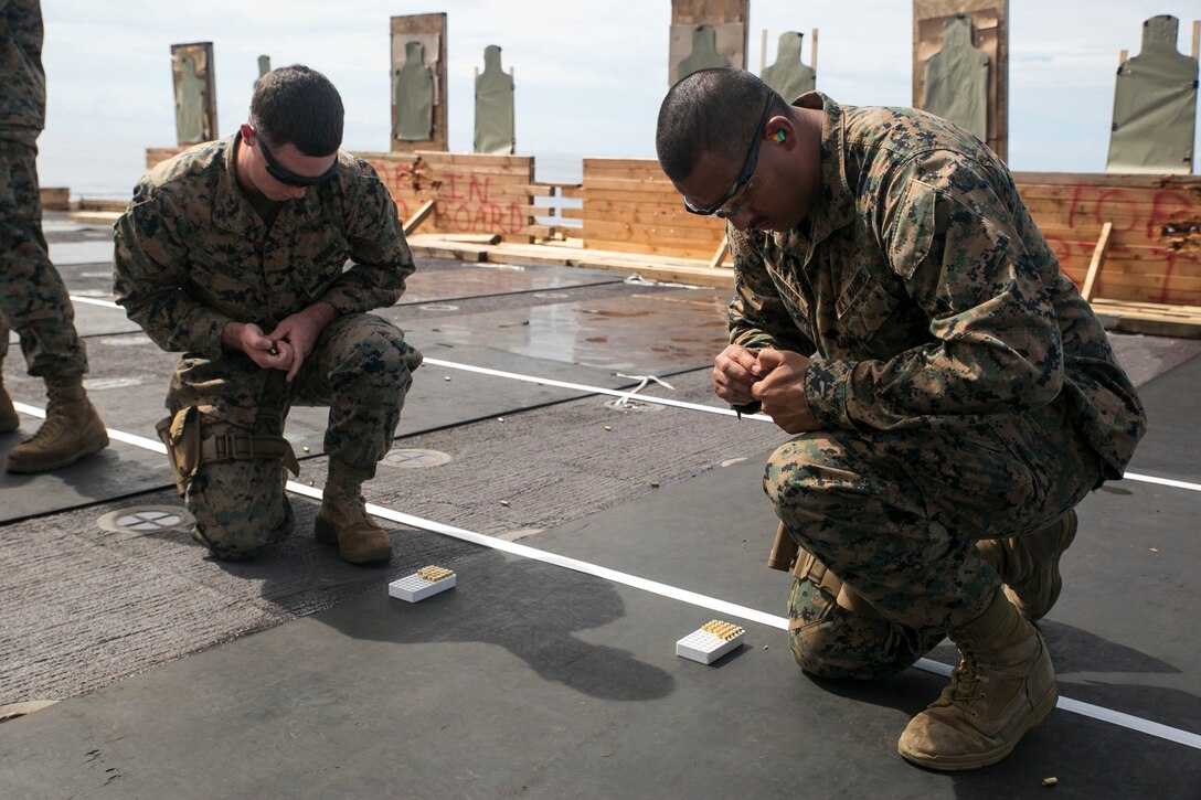 Lance Cpls. Kevin A. Cortez, right, and Brandon D. Dodge load magazines Oct. 31 on the flight deck of the USNS Sacagawea. Marines further developed their marksmanship fundamentals during two days of live-fire. The live-fire was conducted as training for the Marines participating in T-AKE 14-2, a maritime pre-positioned force, multi-country theater security cooperation event which deployed from Okinawa and traveled the Asia-Pacific area of operations. Cortez, from San Antonio, Texas, is a ground radio repairman, and Dodge, from New Bern, North Carolina, is a field radio operator. Both are assigned to the Provisional Rifle Platoon with Combat Logistics Detachment 379, Headquarters Regiment, 3rd Marine Logistics Group, III Marine Expeditionary Force. 