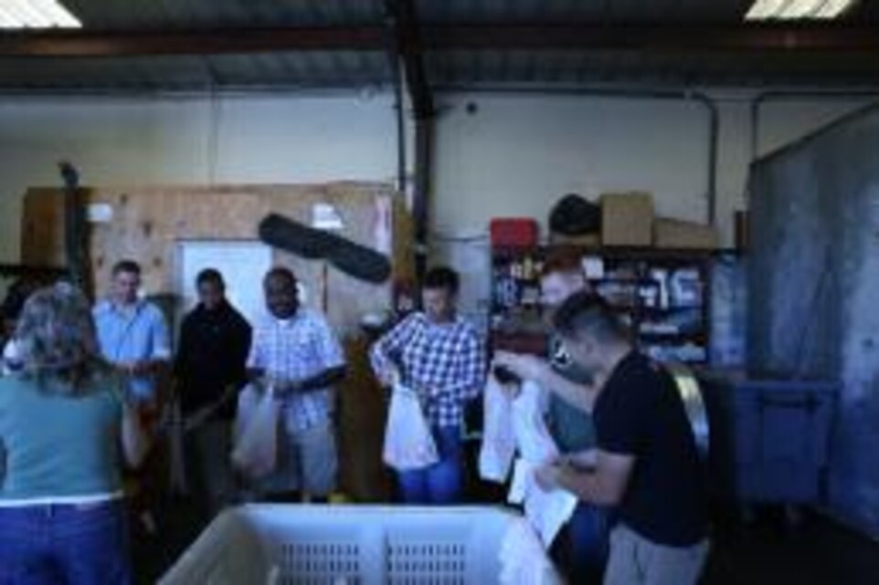 Marines, sailors and civilians bag fresh onions for low-income families who cannot afford groceries from the local San Bernardino Helping Hands Food Pantry, Saturday. The volunteers bagged over two crates of fresh vegetables, cleaned the warehouse and loaded a truck for the organization. (Official Marine Corps photo by Cpl. Kate Seiler/ Released)