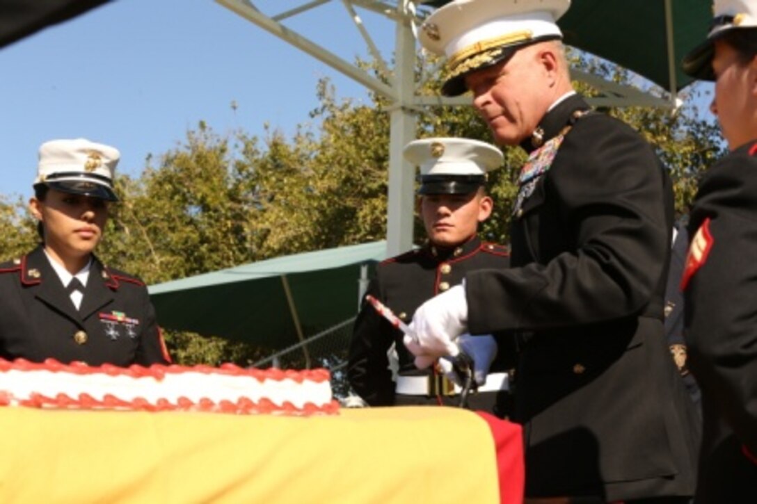 Maj. Gen. Lewis A. Craparotta, Combat Center Commanding General, cuts the first piece of the birthday cake with the Mameluke Sword during the uniform pageant and cake-cutting ceremony at Lance Cpl. Torrey L. Gray Field, Nov. 6, 2014. The oldest Marine in attendance was retired Marine Corps Sgt. Maj. Ray V. Wilburn, who passed on the first piece of cake to Pvt. Brandon Munguia, student, Marine Corps Communication-Electronics School. (Official Marine Corps photo by Cpl. Charles Santamaria/ Released)


