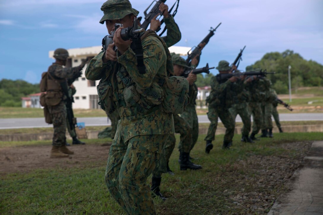 Members of the Royal Brunei Land Force and U.S. Marines practice military operations on urbanized terrain tactics Nov. 10 at the Penanjong Garrison, Tutong, Brunei. Service members participated in MOUT training as part of Cooperation Afloat Readiness and Training 2014 to learn tactics for operating in urban areas such as towns and cities. CARAT maritime exercise series promotes regional security cooperation, mutual understanding, and enhances interoperability among participating forces. The Royal Brunei Land Force service members are with 1st Battalion, RBLF. The U.S. Marines are with 2nd Battalion, 9th Marine Regiment currently assigned to 4th Marine Regiment, 3rd Marine Division, III Marine Expeditionary Force under the unit deployment program. 