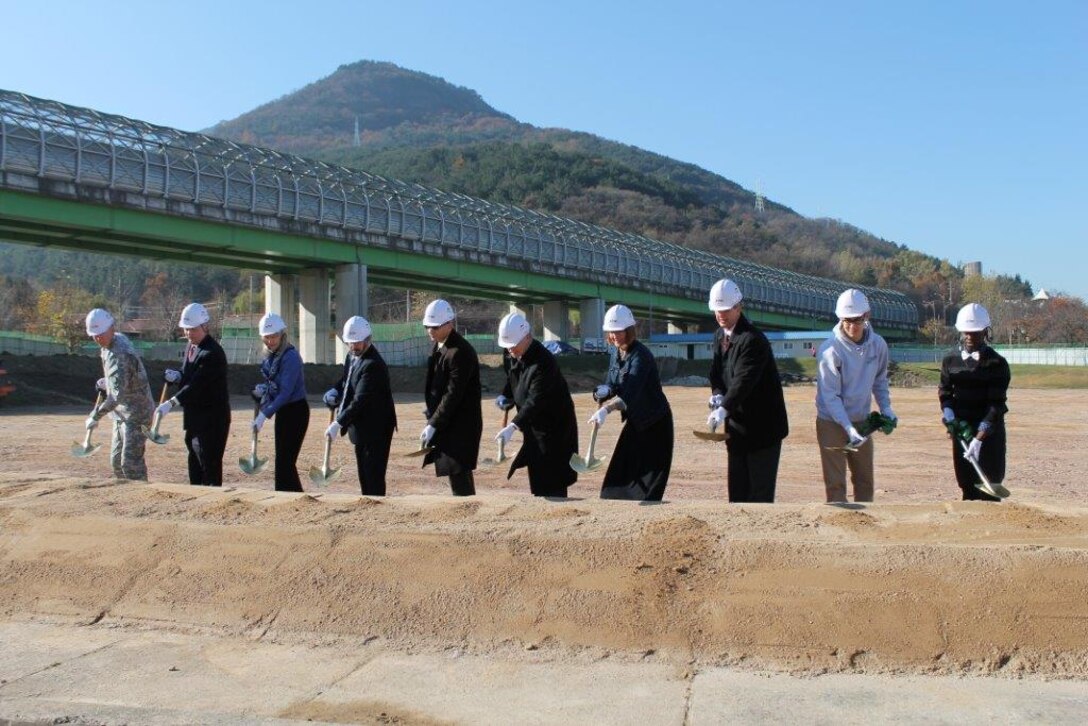 Another big step towards developing Area IV was taken as ground was broken for the new Middle/High School on Camp Walker at U.S Army Garrison Daegu. Far East District construction division chief Samuel Adkins (third from right) is joined by other dignitaries at the groundbreaking ceremony Nov. 19.