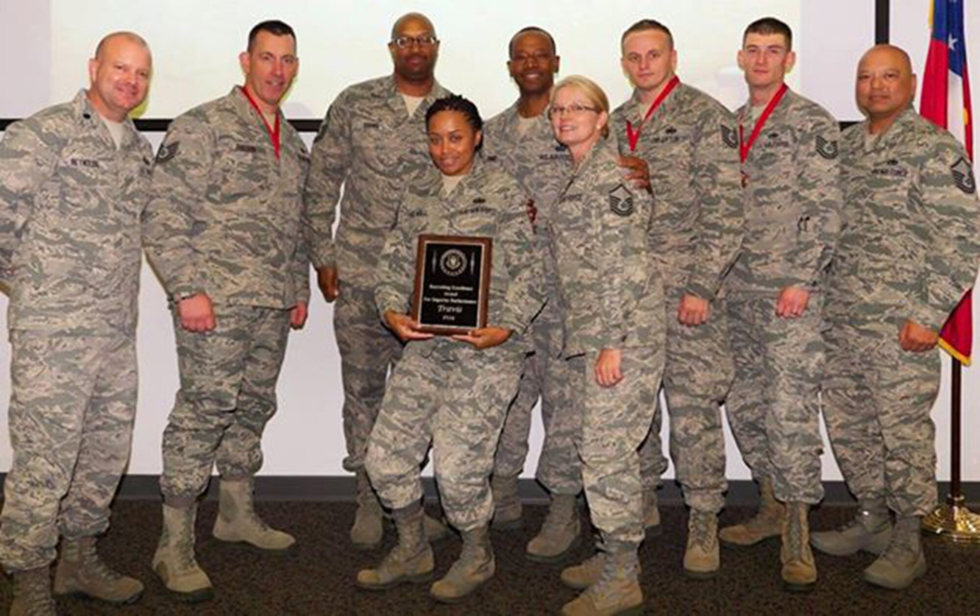 TRAVIS AIR FORCE BASE, Calif. -- The 349th Air Mobility Wing Reserve Recruiting Squadron was presented the Recruiting Excellence Award for Superior Performance.   Pictured here, front row: Master Sgts. Michaela Brown and Rhonda Cano, 349th AMW/RS. Back row, from the left: Lt. Col. Timothy Reynolds, 452nd AMW Recruiting Squadron commander, March Air Reserve Base, Calif., Tech. Sgt. Bill Pullion, Senior Master Sgt. Alexander Brown, 349th AMW/RS; Chief Master Sgt. William Jones, 452nd AMW/RS superintendent, TSgts. Jeffrey Madden and Robert Thames, 349th AMW/RS, and Master Sgt. James Muna, 349th AMW/RS. (Courtesy photo)