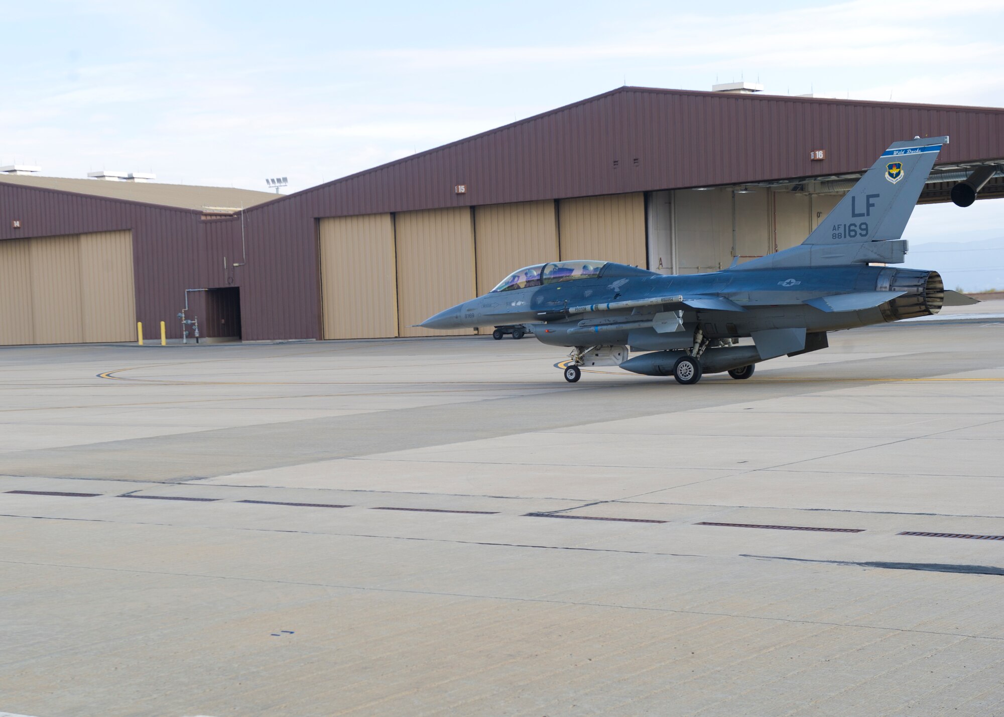 Lt Col Jerod Rick, 54th Fighter Group chief of standardization and evaluation and 1st Lieutenant Taylor Roberts , a Basic Course student in the 311th Fighter Squadron, taxi out in an F-16 Fighting Falcon at Holloman Air Force Base, N.M., Nov. 13. Under the new training syllabus for the F-16, all students are prepared for the possibility of flying their first flight alone by training in 8 simulator sorties during their academic phase, including an Emergency Procedures Evaluation from an F-16 Flight Evaluator. (U.S. Air Force photo by Senior Airman Daniel E. F. Liddicoet/Released)

