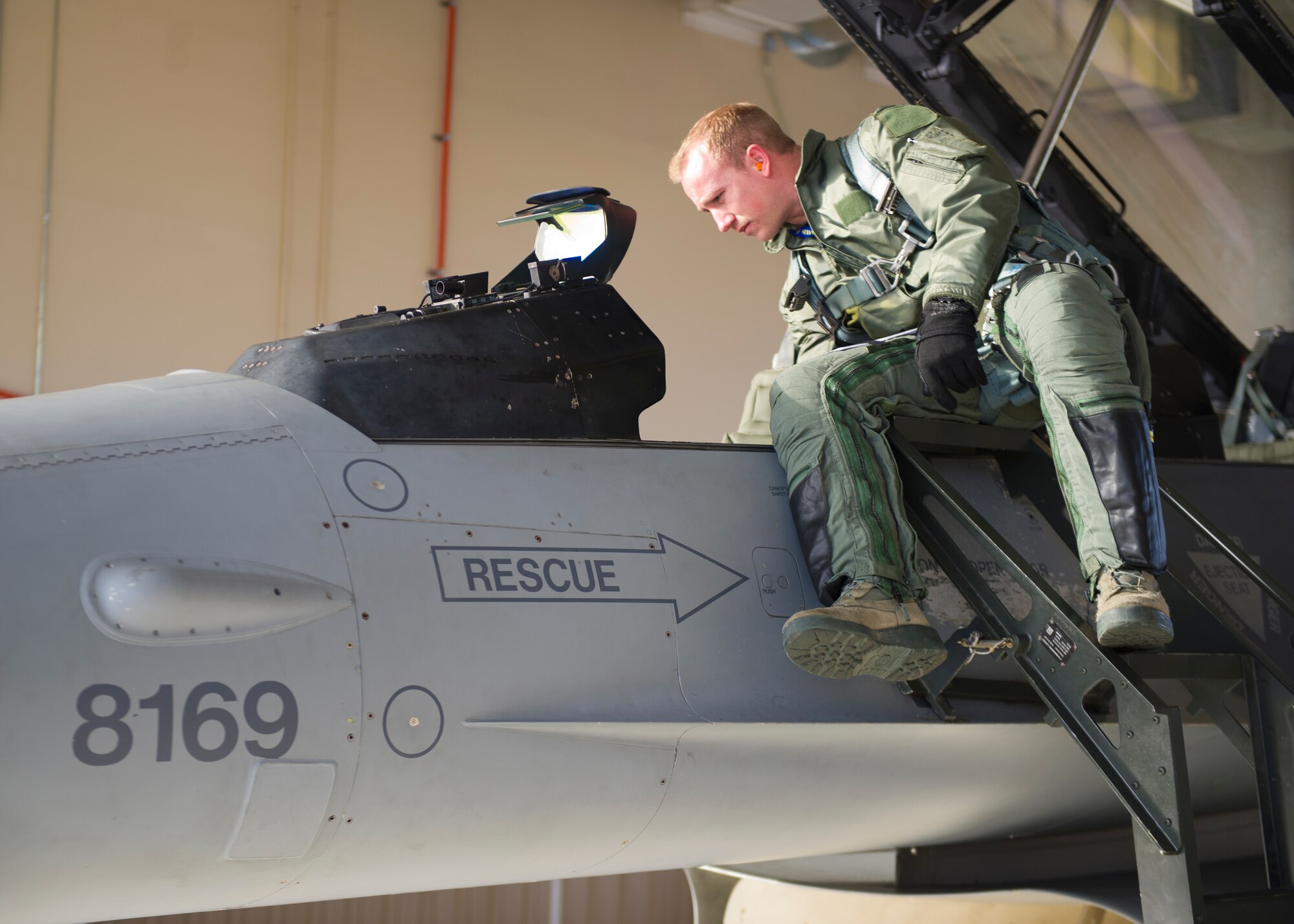 Lt. Col. Jerod Rick, 54th Fighter Group chief of standardization and evaluation, prepares to enter the cockpit on an F-16 Fighting Falcon with 1st Lt. Taylor Roberts, a Basic Course student in the 311th Fighter Squadron, at Holloman Air Force Base, N.M., Nov. 13. 14 students total were in the first-ever F-16 Basic Course student training program that began Sept. 29, 2014. It is estimated that by June 2015, Holloman will be responsible for 45 percent of F-16 training for the entire Department of Defense. (U.S. Air Force photo by Senior Airman Daniel E. F. Liddicoet/Released)
