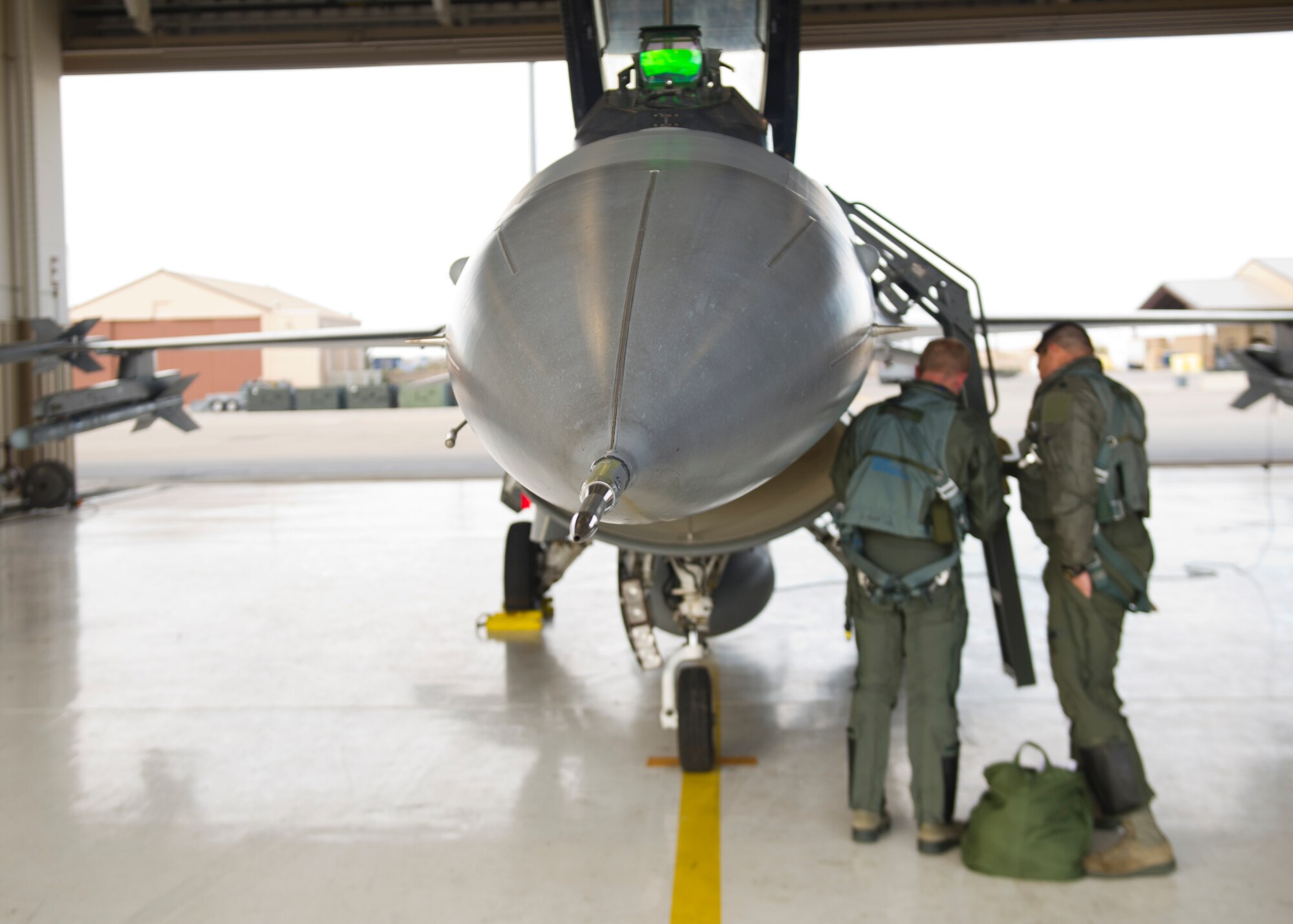 Lt. Col. Jerod Rick, 54th Fighter Group chief of standardization and evaluation, performs a preflight inspection on an F-16 Fighting Falcon with 1st Lt. Taylor Roberts, a Basic Course student in the 311th Fighter Squadron, at Holloman Air Force Base, N.M., Nov. 13. Roberts became the first F-16 Basic Course student to get airborne in the jet at Holloman. It was his first of 57 planned flights in his syllabus. (U.S. Air Force photo by Senior Airman Daniel E. F. Liddicoet/Released)