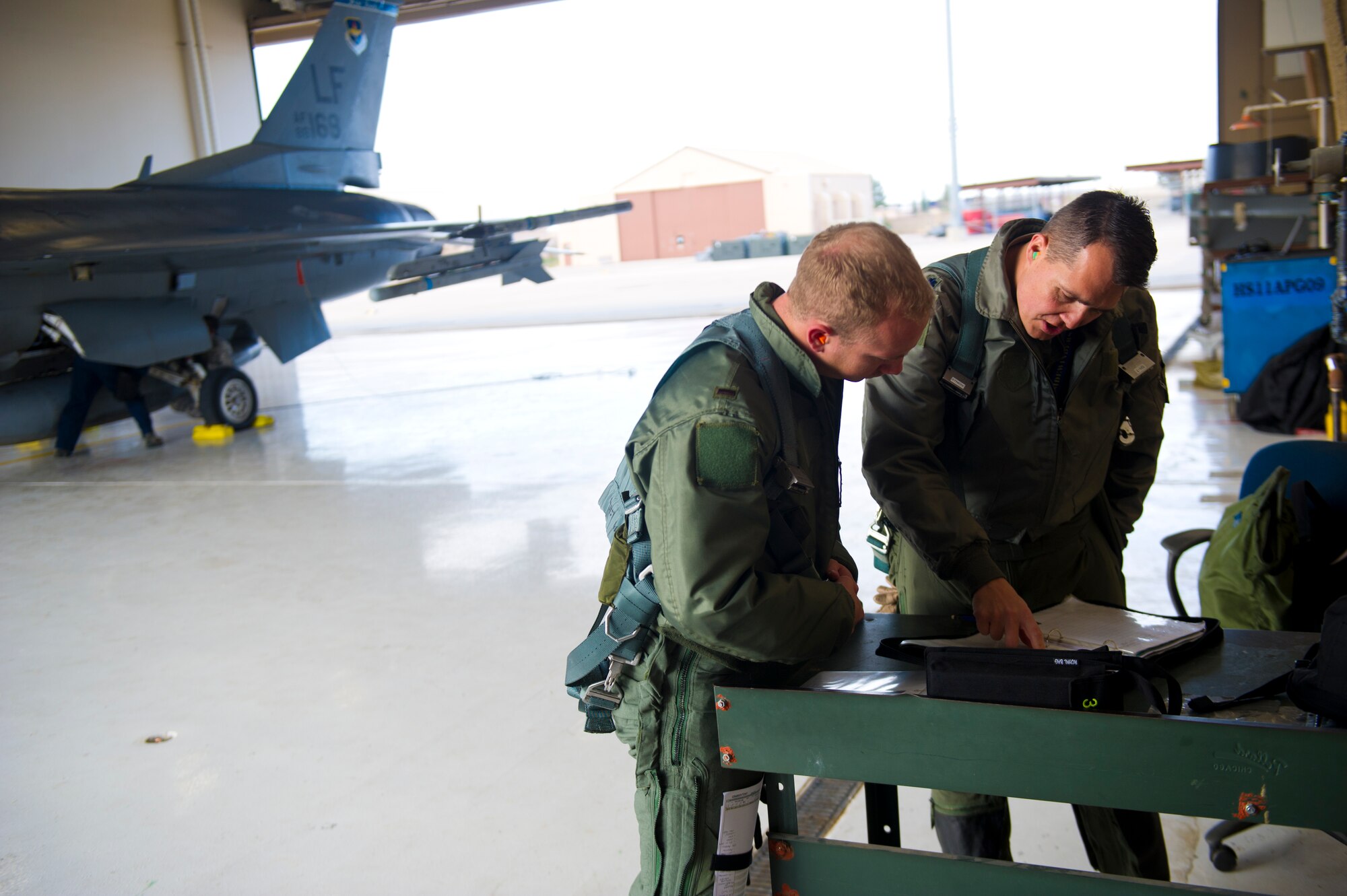 Lt. Col. Jerod Rick, 54th Fighter Group chief of standardization and evaluation, prepares to perform a preflight inspection on an F-16 Fighting Falcon with 1st Lt. Taylor Roberts, a Basic Course student in the 311th Fighter Squadron at Holloman Air Force Base, N.M., Nov. 13. Roberts became the first F-16 Basic Course student to get airborne in the jet at Holloman. It was his first of 57 planned flights in his syllabus. (U.S. Air Force photo by Senior Airman Daniel E. F. Liddicoet/Released)