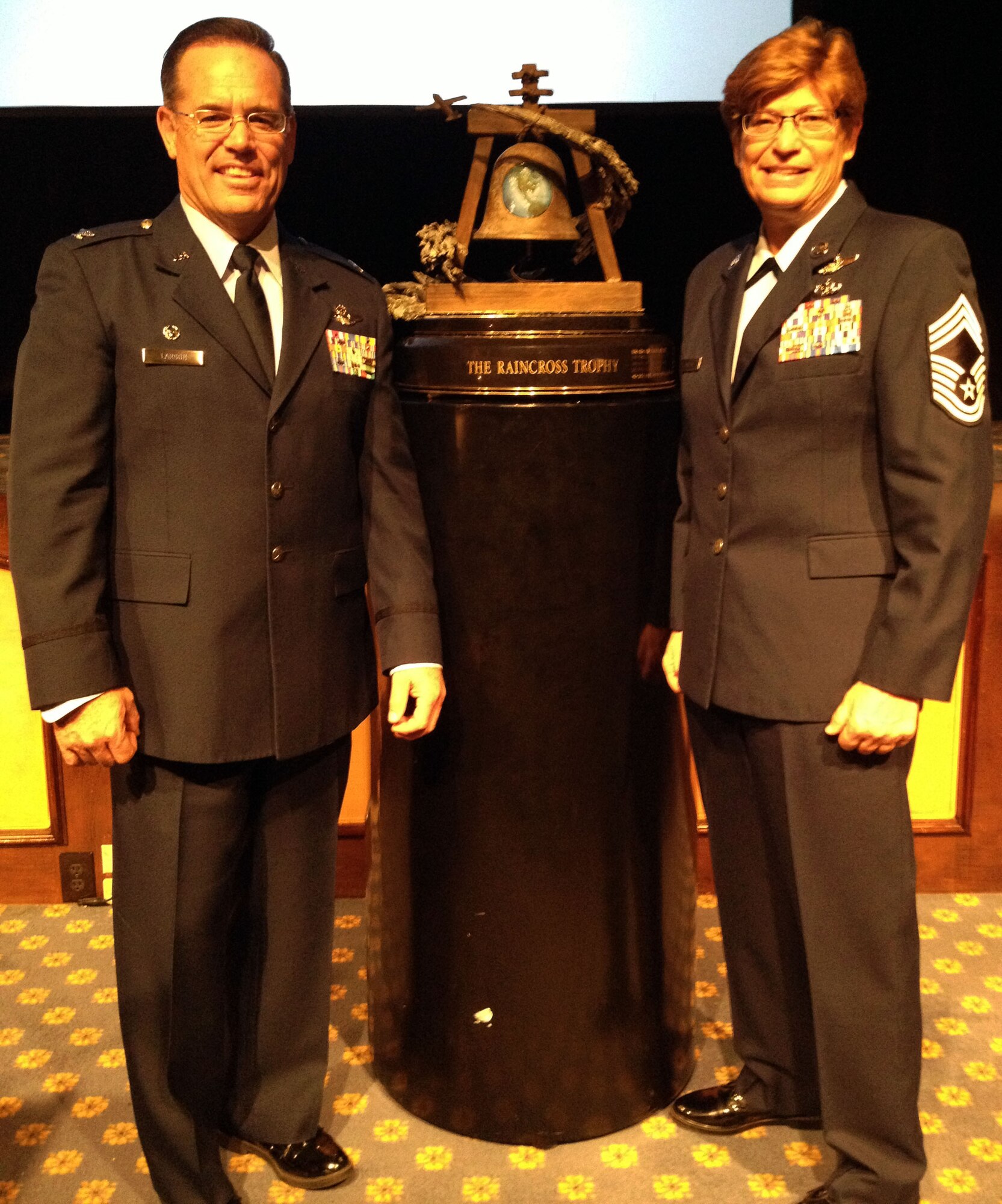 Col. Mark S. Larson, Commander, 931st Air Refueling Group, McConnell Air Force Base, Kan., and Chief Master Sgt. Kathleen E. Lowman, 931st Air Refueling Group Superintendent, pose with the Raincross Trophy at the annual Raincross Awards Dinner in Riverside, Calif., Nov. 19, 2014. The 931st Air Refueling Group was awarded the trophy this year and named the top unit in 4th Air Force. This marked the first time the 931st has been awarded the Raincross Trophy in the unit's history.  (Courtesy Photo)