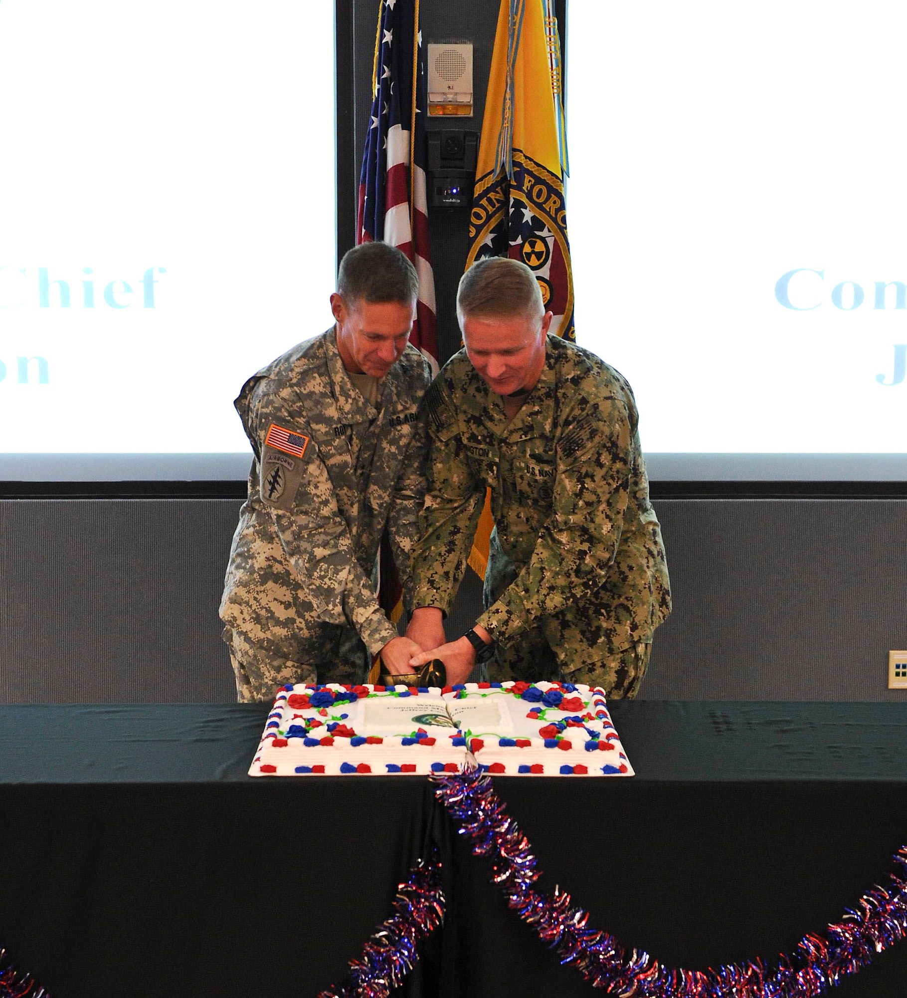 U.S. Army Maj. Gen. William Roy, Joint Task Force Civil Support commander, and U.S. Navy Command Master Chief Jeffrey Covington, JTF-CS senior enlisted leader, cut cake during a change of responsibility ceremony at Fort Eustis, Va., Nov. 14, 2014. Covington’s most recently served as the Force Master Chief of the Navy Expeditionary Combat Command. (Official DOD photo by U.S. Navy Petty Officer 1st Class Brian Dietrick)