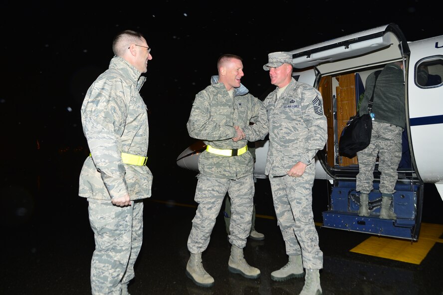 Chief Master Sgt. of the Air Force James Cody is greeted by Col. Michael Grismer, 436th Airlift Wing commander, and Chief Master Sgt. Stanley Cadell, 436th AW command chief, Nov. 17, 2014, at Dover Air Force Base, Del. Cody and his wife, retired Chief Master Sgt. Athena Cody, visited with Team Dover Airmen and their families over a three day visit. (U.S. Air Force photo/Airman 1st Class William Johnson)