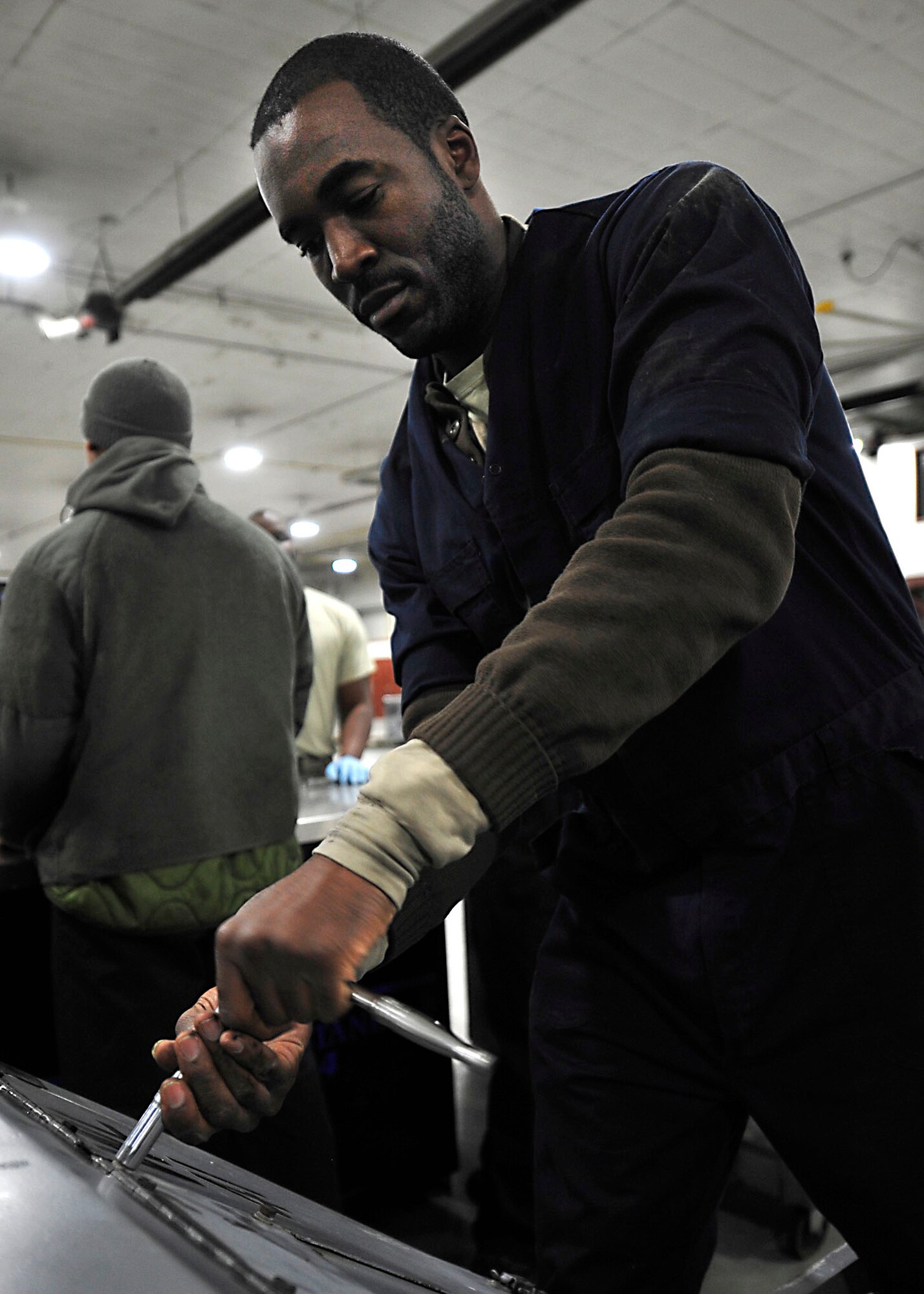 U.S. Air Force Staff Sgt. Jamaal Blakeney, 1st Maintenance Squadron Aerospace Ground Equipment technician, performs a Phase II inspection on a bomb lift at Langley Air Force Base, Va., Nov. 19, 2014. Bomb lifts receive yearly inspections to ensure the equipment which supports aircraft remain in operating condition. (U.S. Air Force photo by Airman 1st Class Breonna Veal/Released)