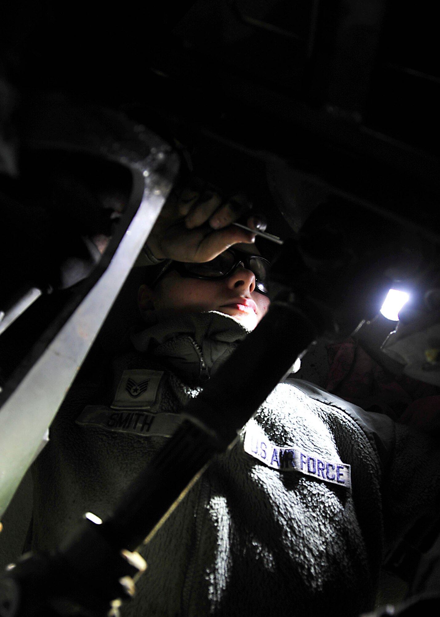 U.S. Air Force Staff Sgt. Tara Smith, 1st Maintenance Squadron Aerospace Ground Equipment technician, performs a Phase II inspection on a bomb lift at Langley Air Force Base, Va., Nov. 19, 2014. AGE technicians service, inspect, troubleshoot, repair and perform preventive maintenance on motor-and-engine-driven generator sets, bomb lifts, heaters and other similar support equipment. (U.S. Air Force photo by Airman 1st Class Breonna Veal/Released) 