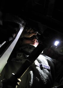 U.S. Air Force Staff Sgt. Tara Smith, 1st Maintenance Squadron Aerospace Ground Equipment technician, performs a Phase II inspection on a bomb lift at Langley Air Force Base, Va., Nov. 19, 2014. AGE technicians service, inspect, troubleshoot, repair and perform preventive maintenance on motor-and-engine-driven generator sets, bomb lifts, heaters and other similar support equipment. (U.S. Air Force photo by Airman 1st Class Breonna Veal/Released) 